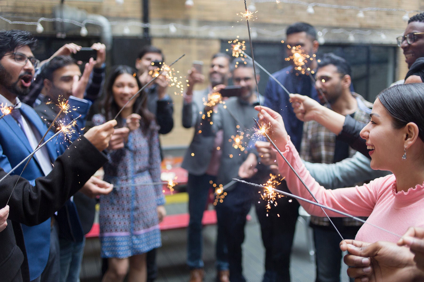 Friends celebrating with sparklers at party