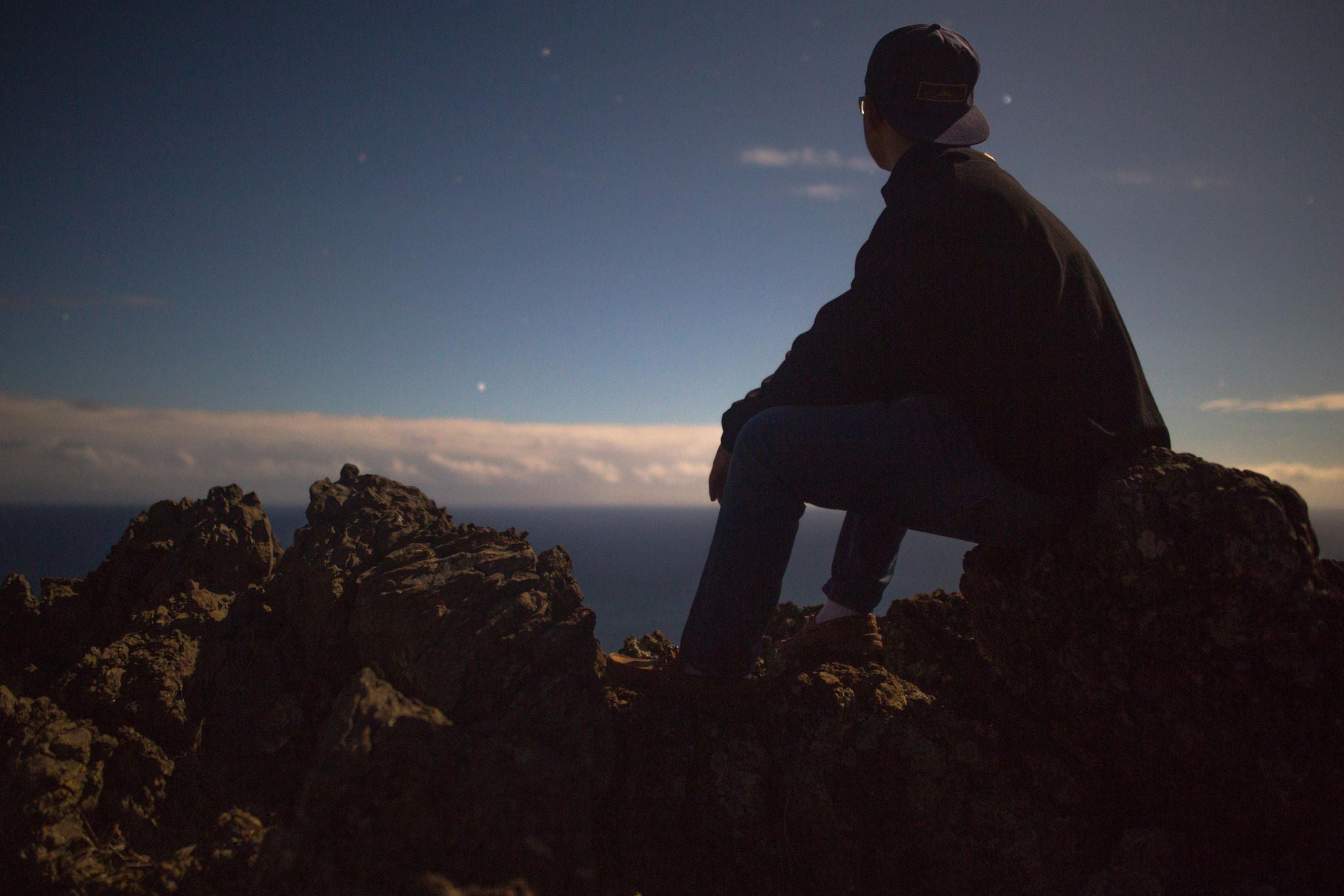 Man with cap ponders into space