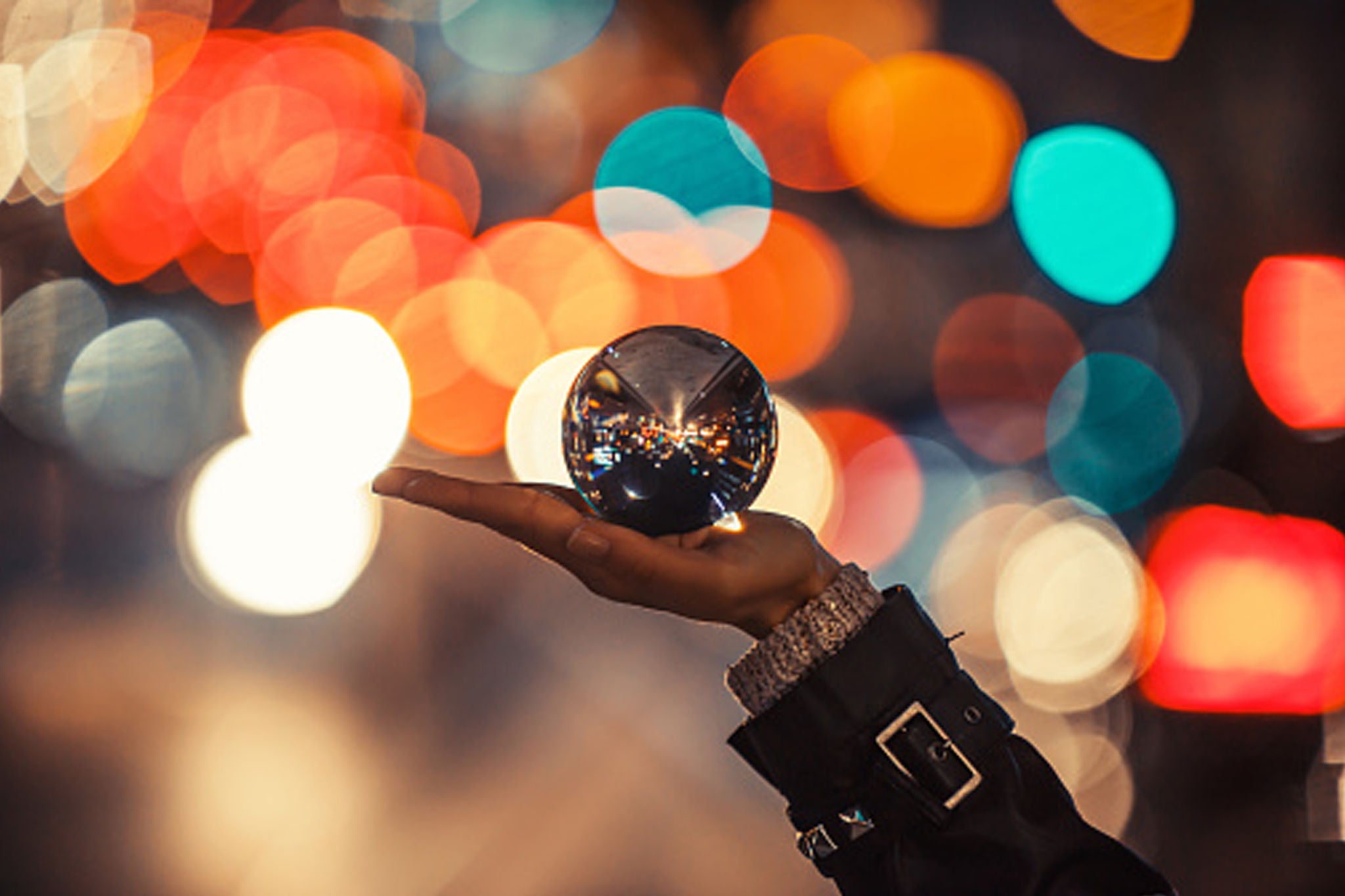 Girl in city holding crystal ball with beautiful bokeh