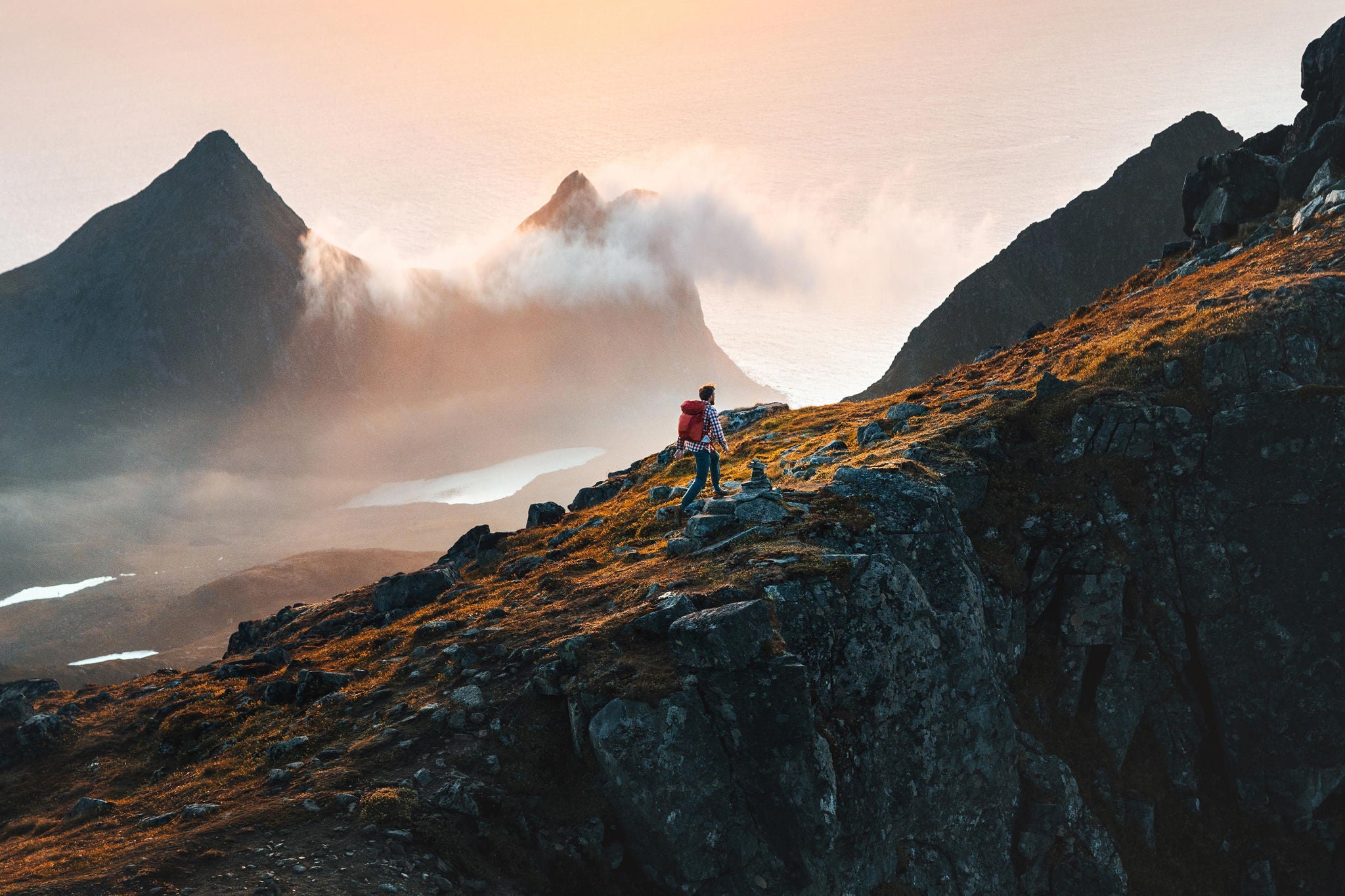 man climbing mountains travelling in Norway