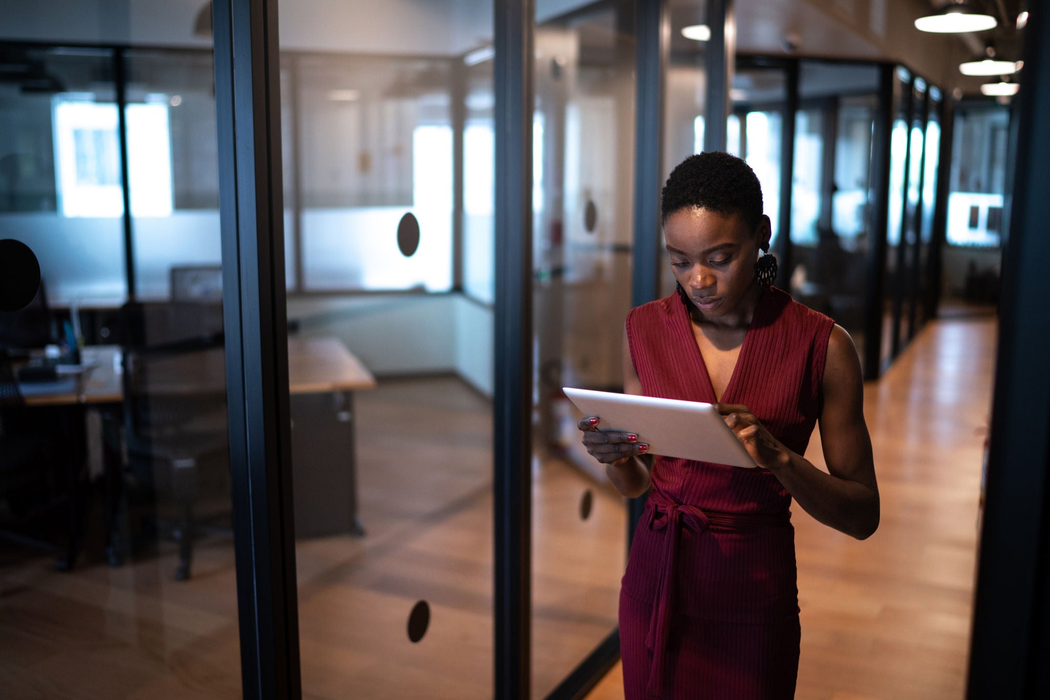 Young businesswoman walking with digital tablet at coworking