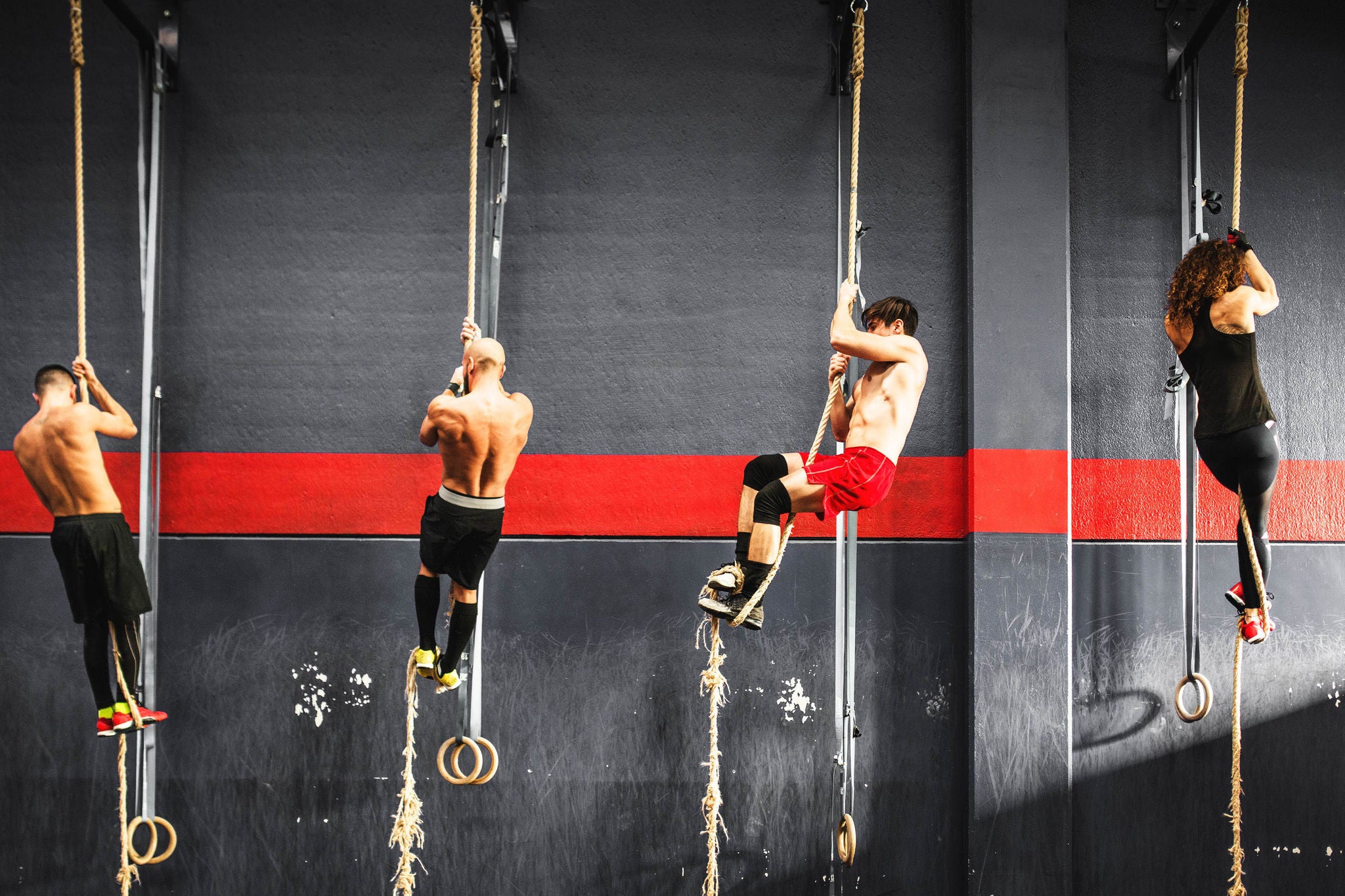 group of athlete climbing the rope on a gym