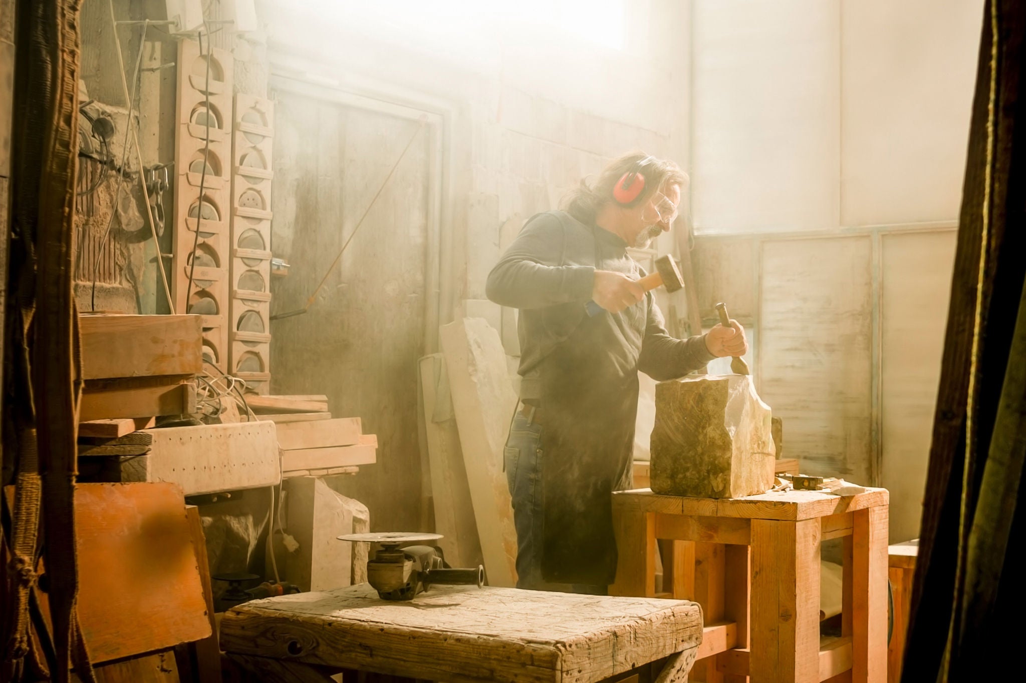 Stonemason chiselling a block of stone