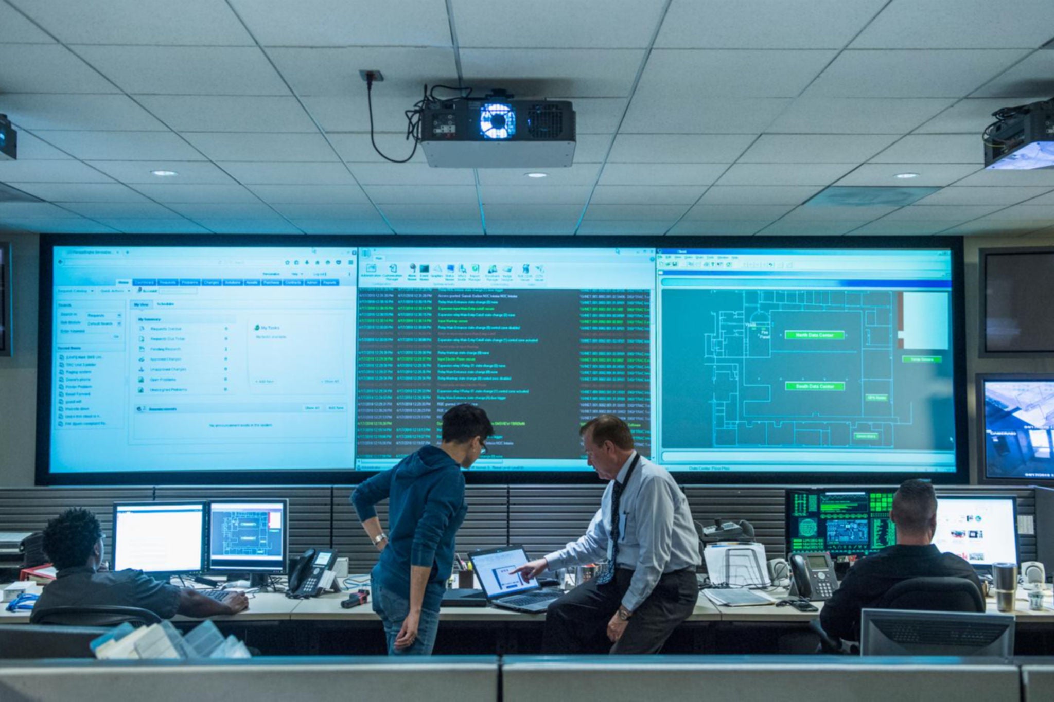 Colleagues working together in server control room