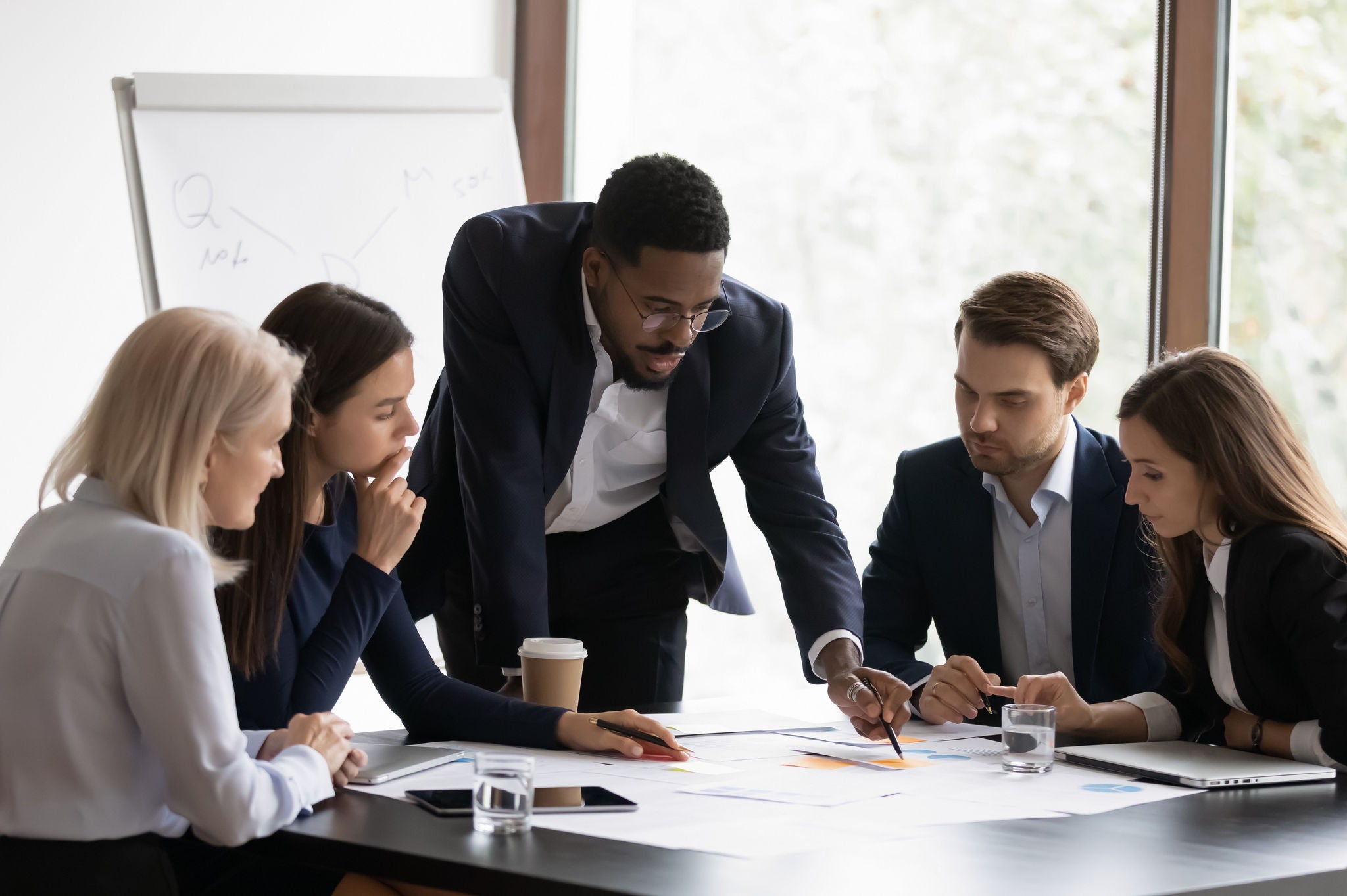 Confident biracial businessman head meeting with diverse colleagues