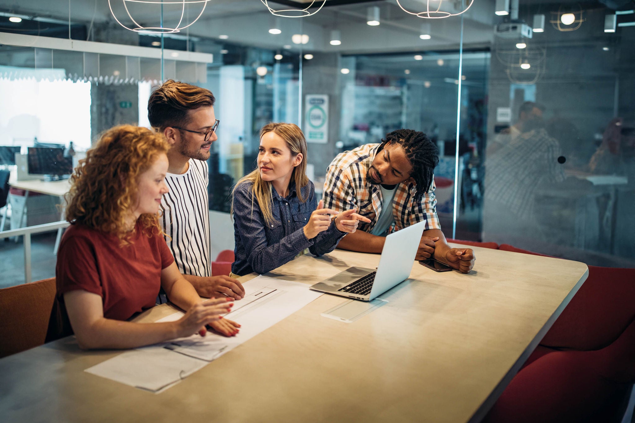 Successful group of business people, designers at work in office