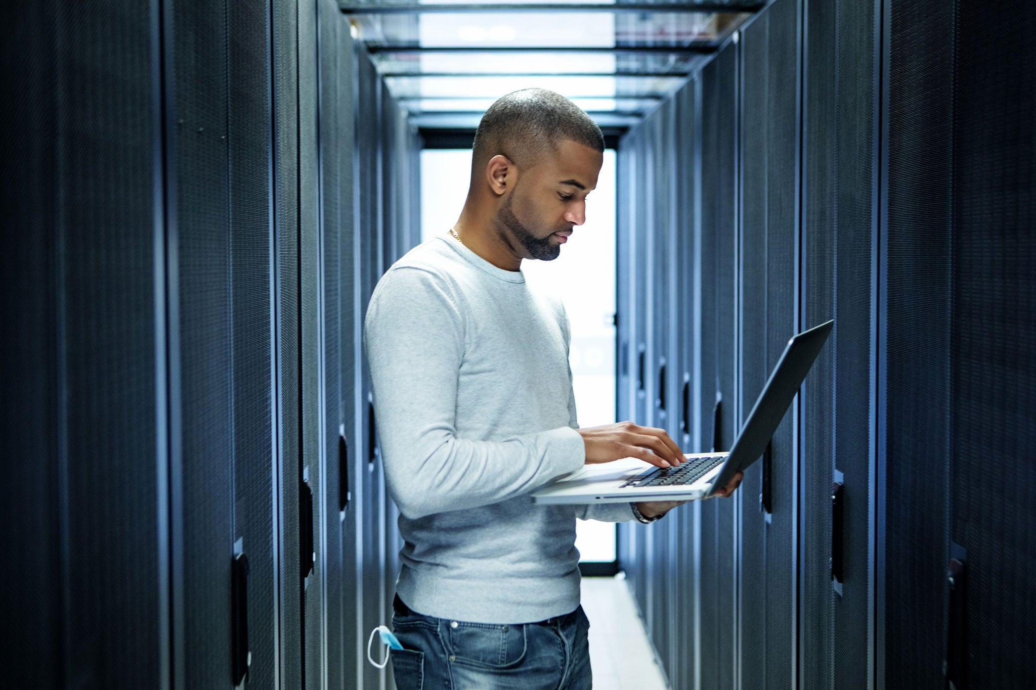 man working laptop server room