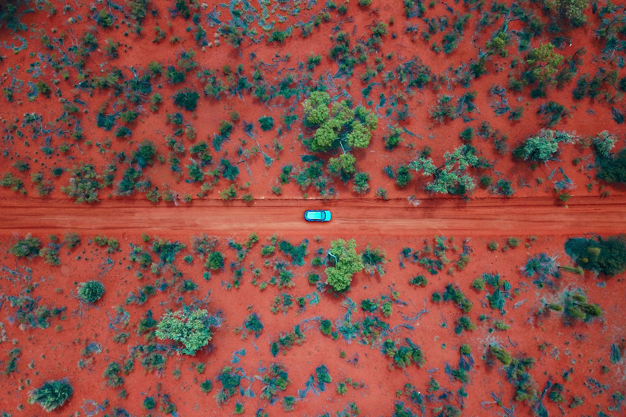 car driving on the red centre roads in the Australian Outback