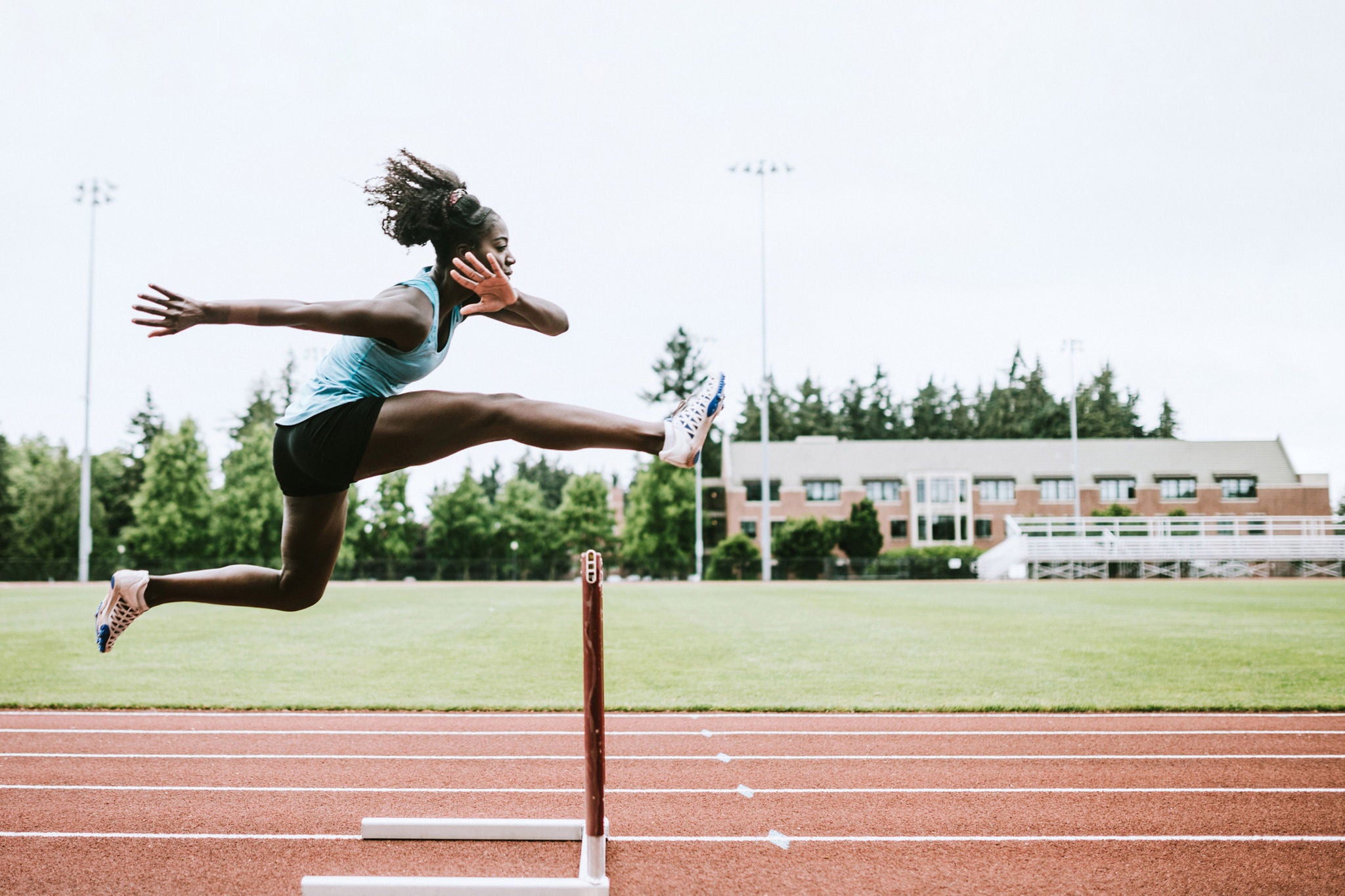 athlete runs hurdles