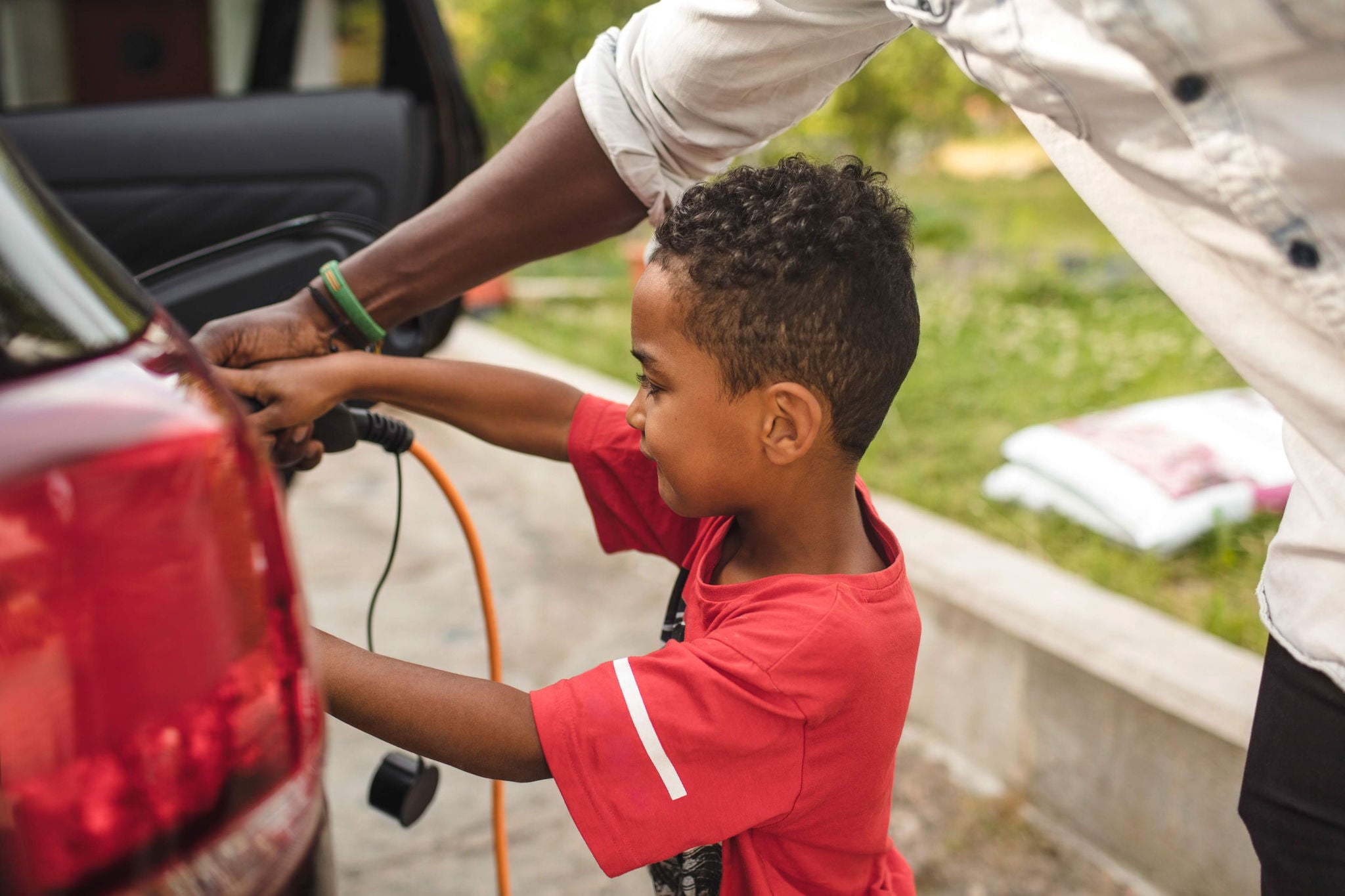 Father and son filling up petrol tank