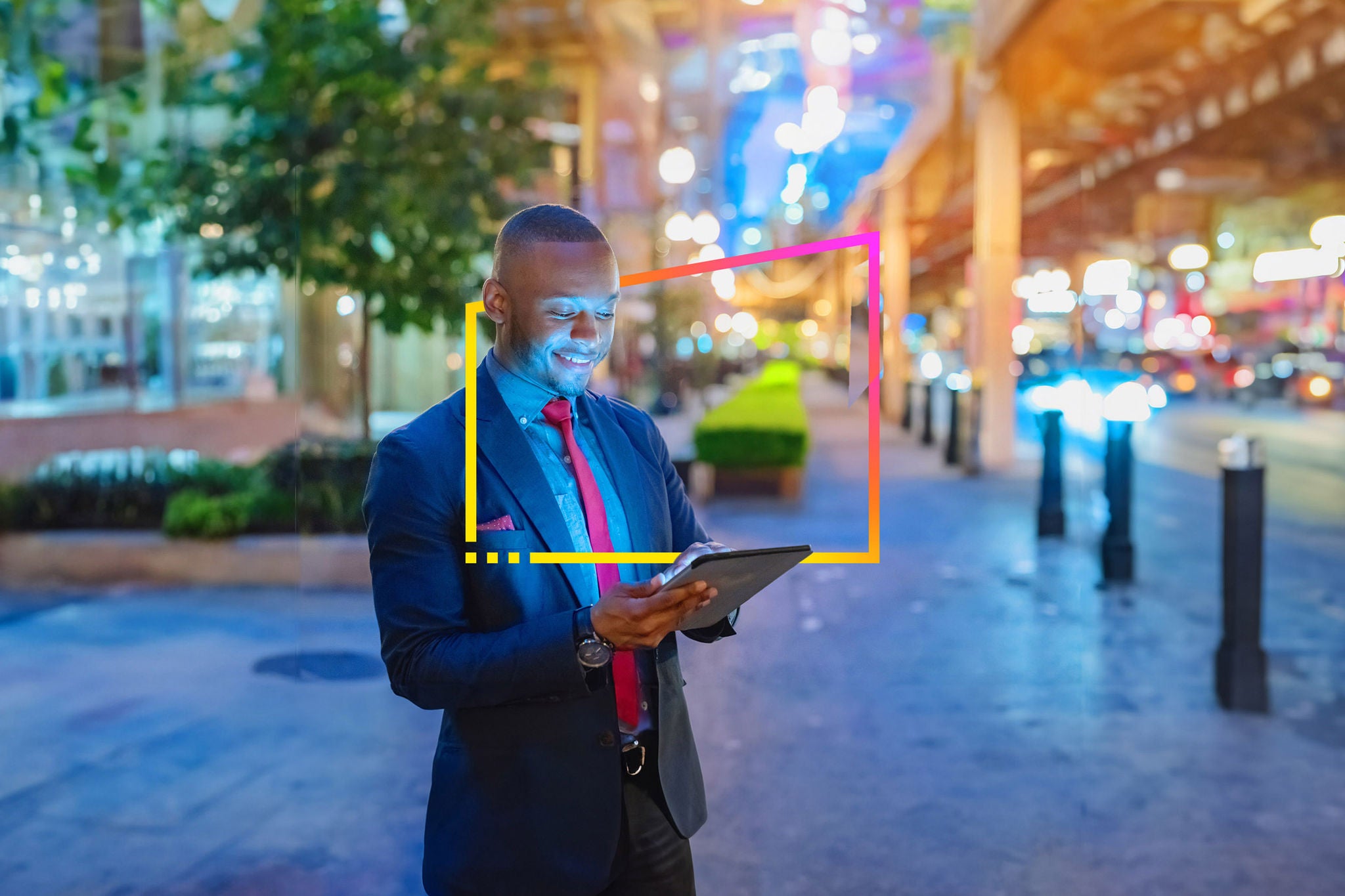 Businessman in the city looking into digital tablet computer