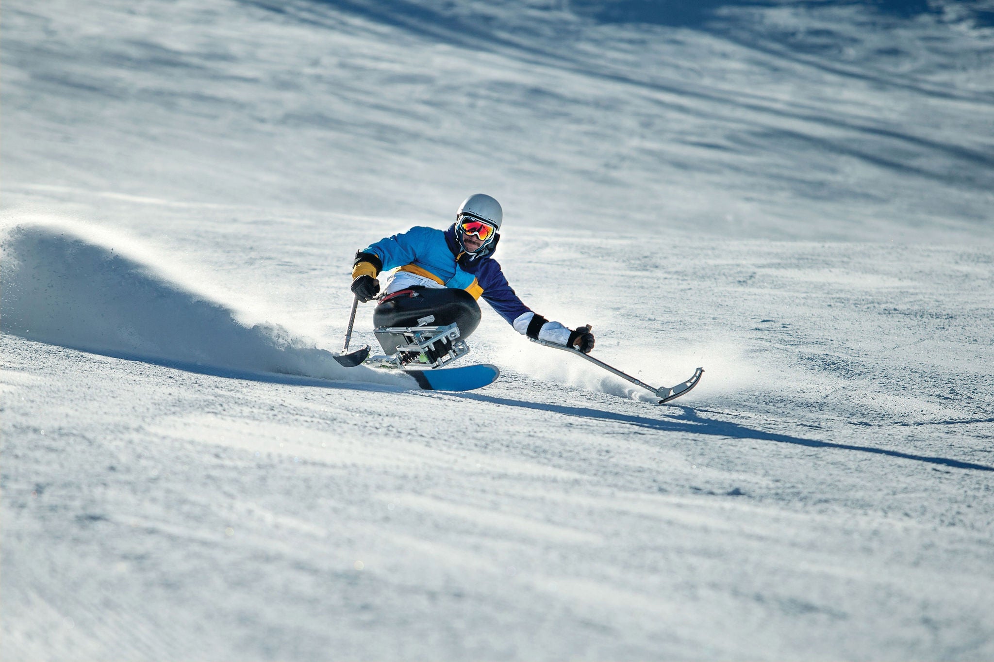 Disabled man snow skiing