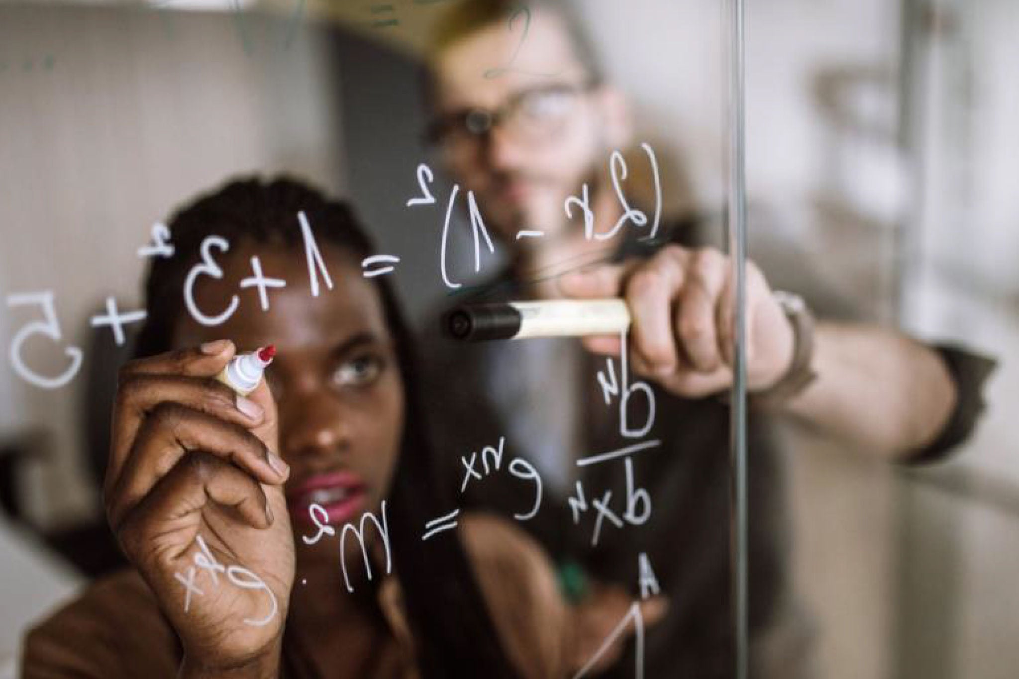 Women righting on the transparent board