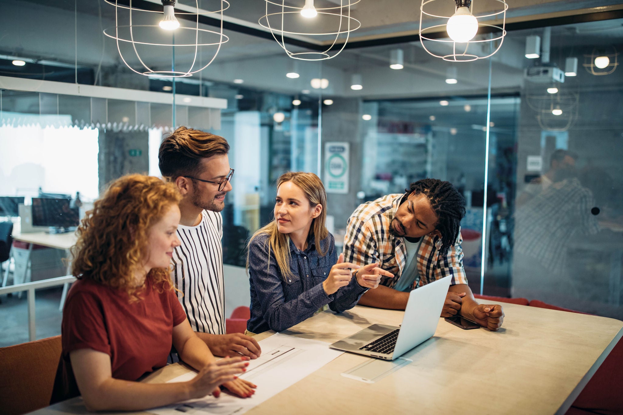 Successful group of designers, business people at work in office