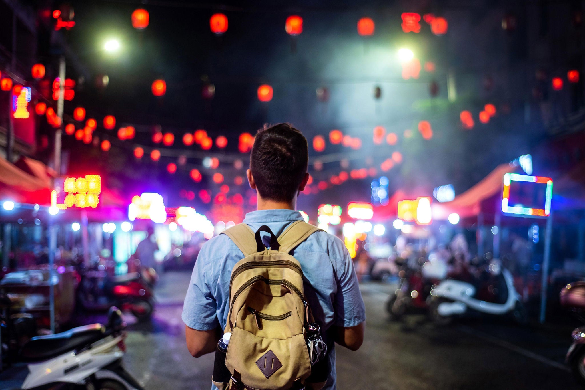 Traveler exploring asian food market street