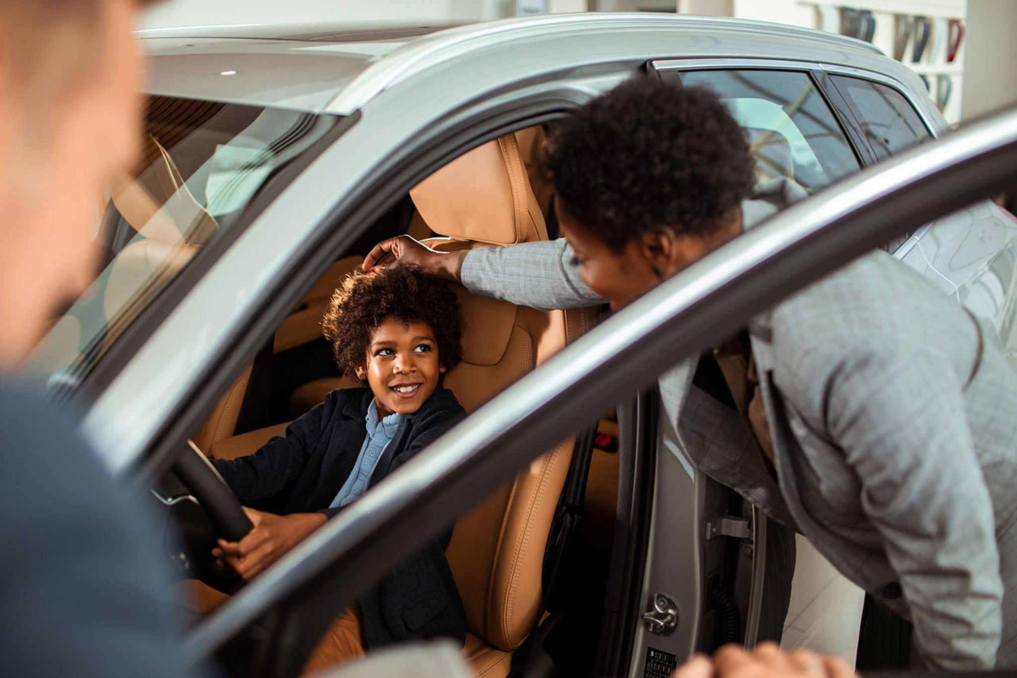 Family testing car at showroom dealership