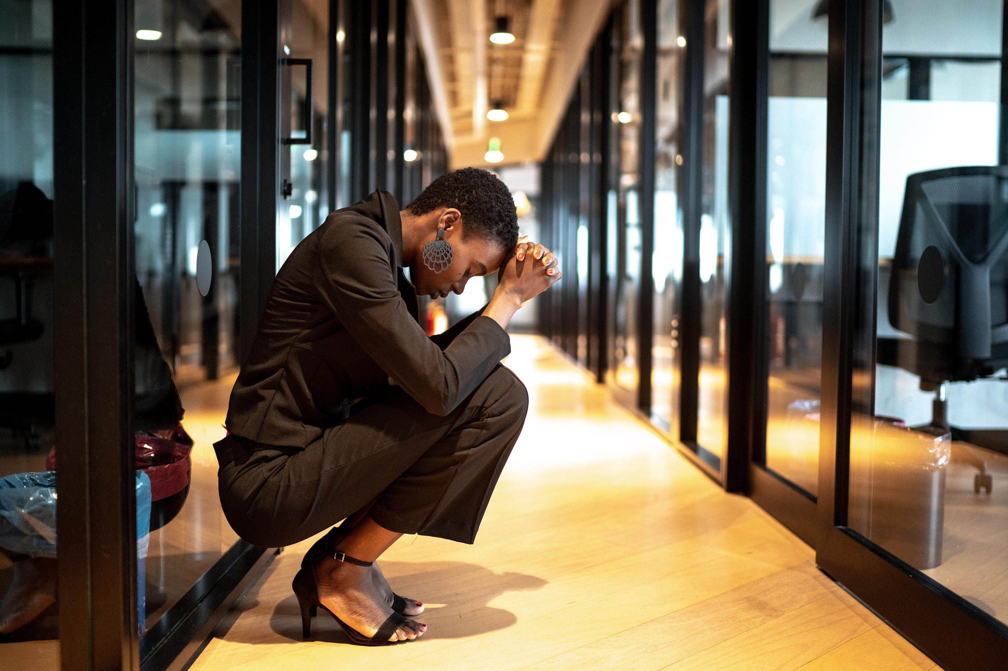 Worried young businesswoman at corridor office