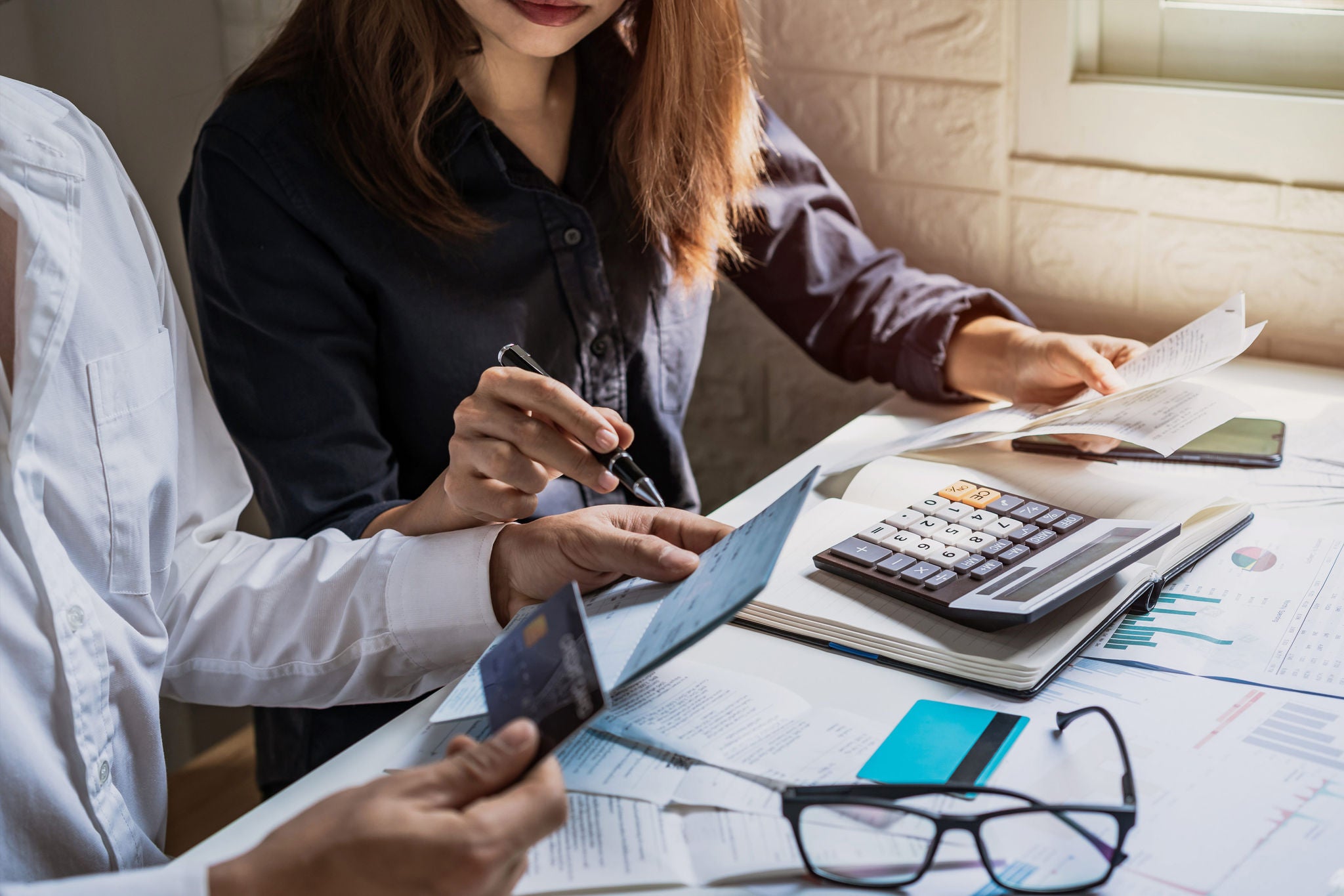 Young couple checking bills at home