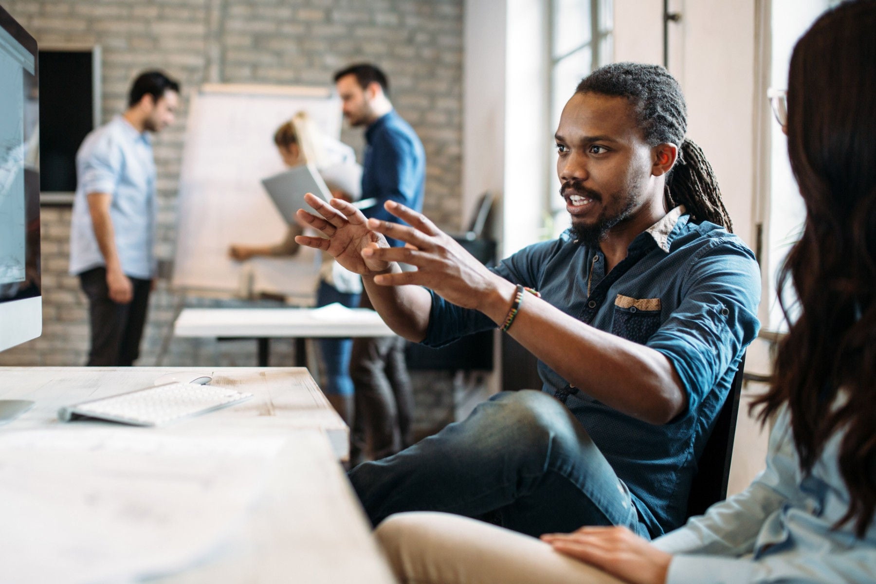 A man explains vision to colleague