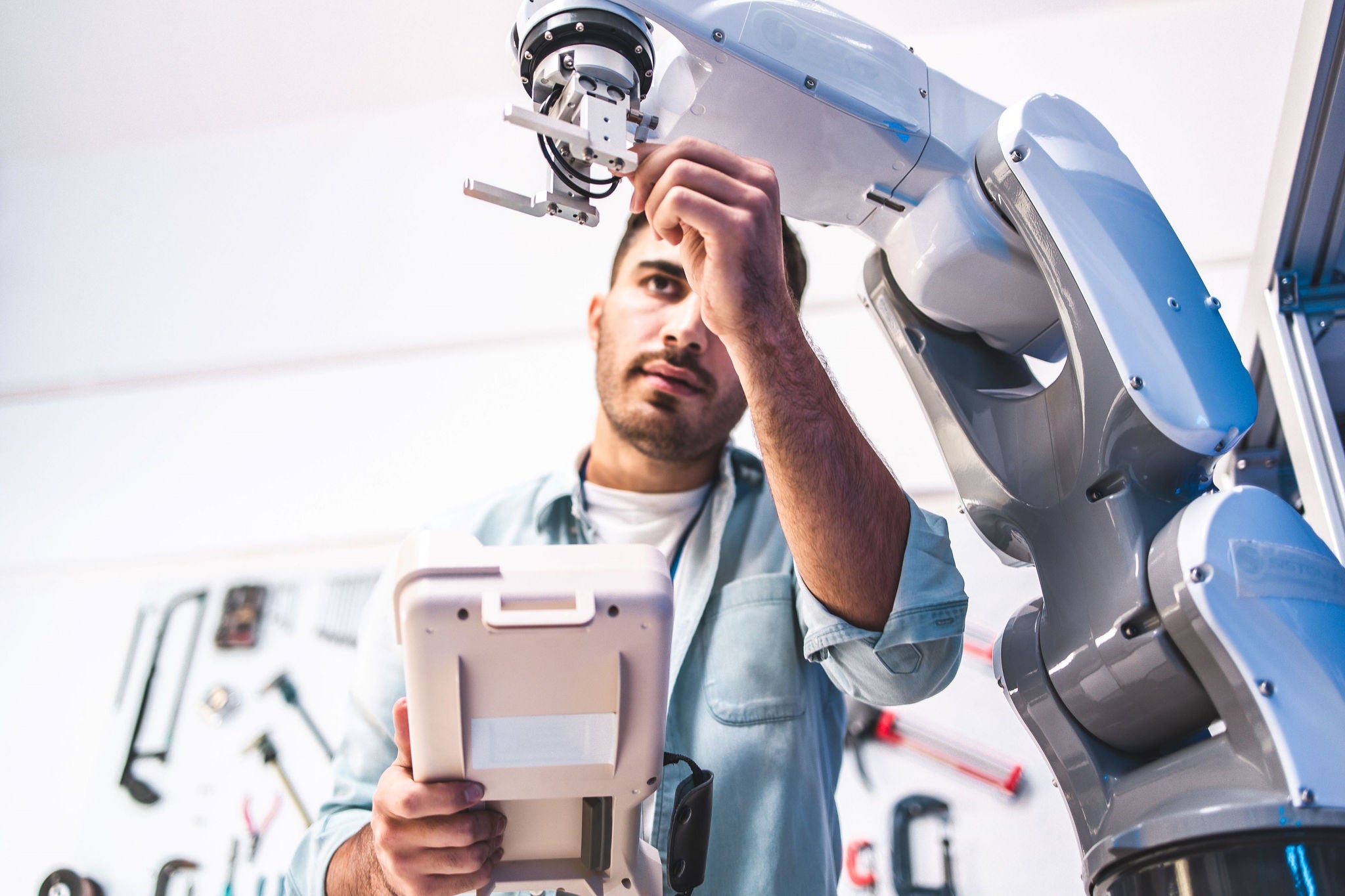 Male engineers maintenance robot arm at lab