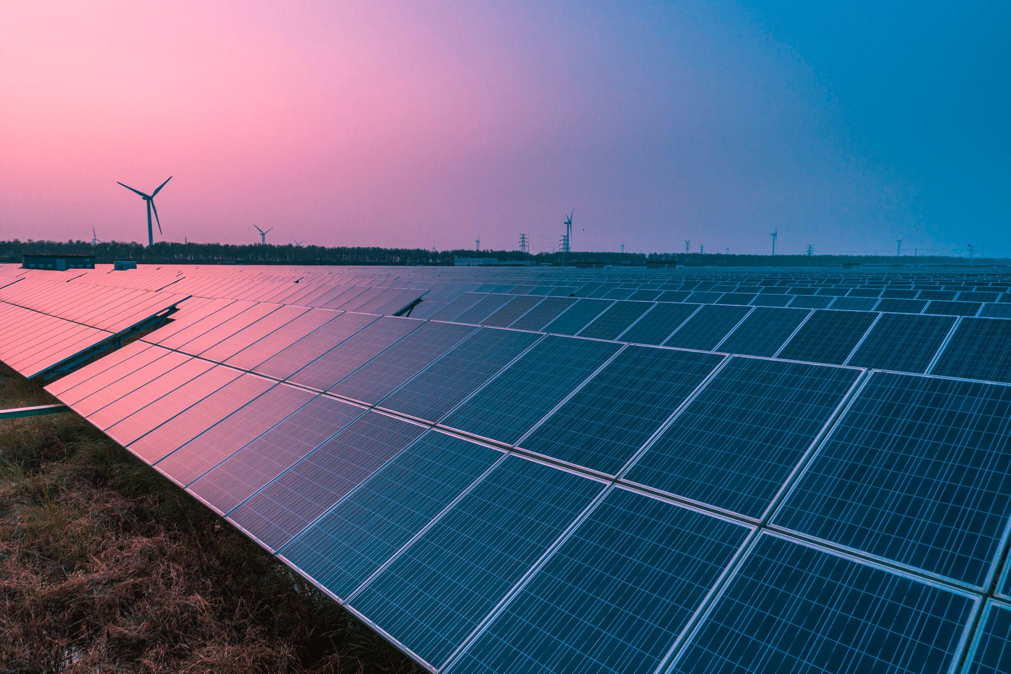 Solar panels with wind turbines on a sunny day,green clean energy concept"n