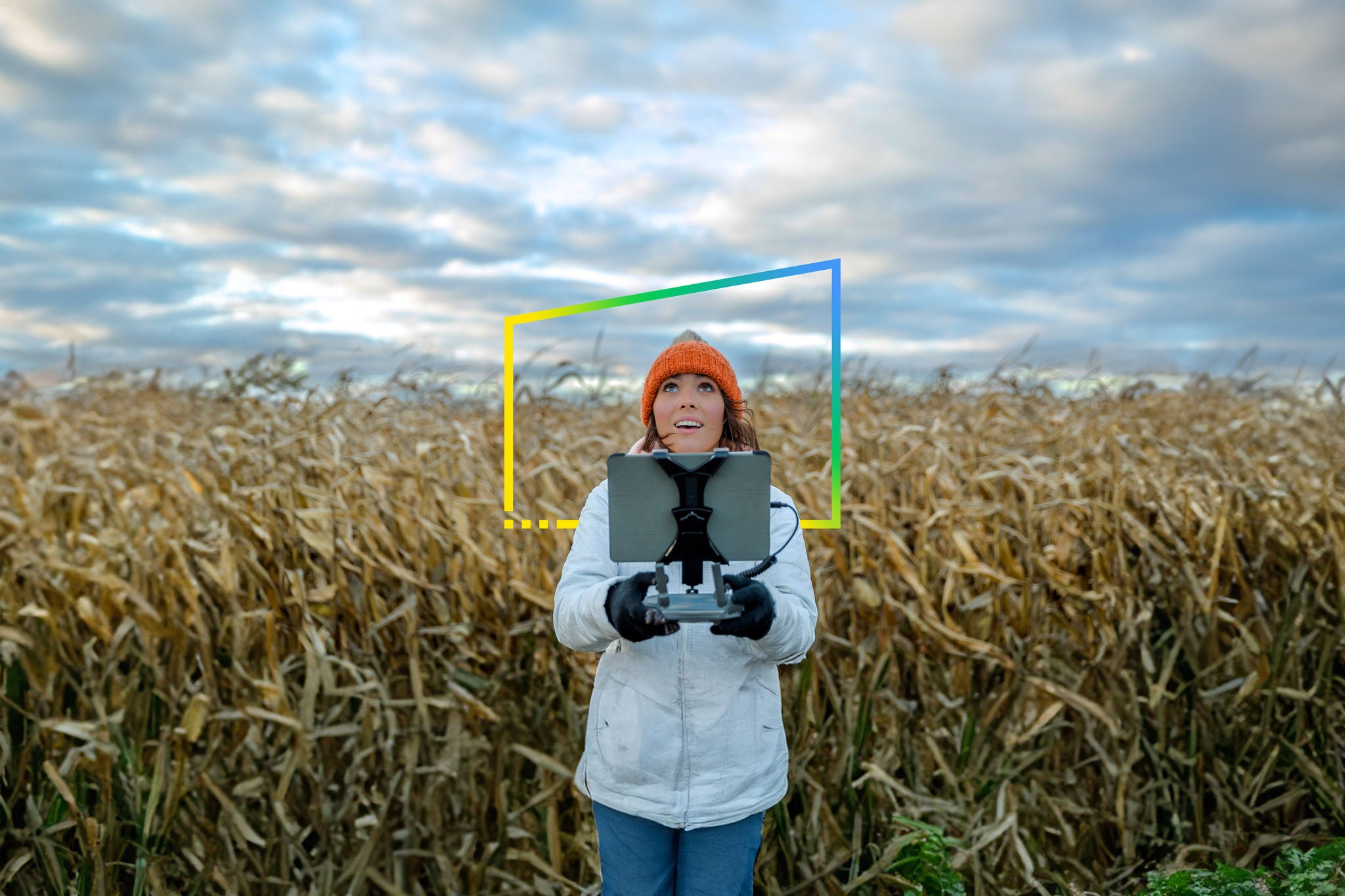 Woman Pilot Using Drone Remote Controller in corn field