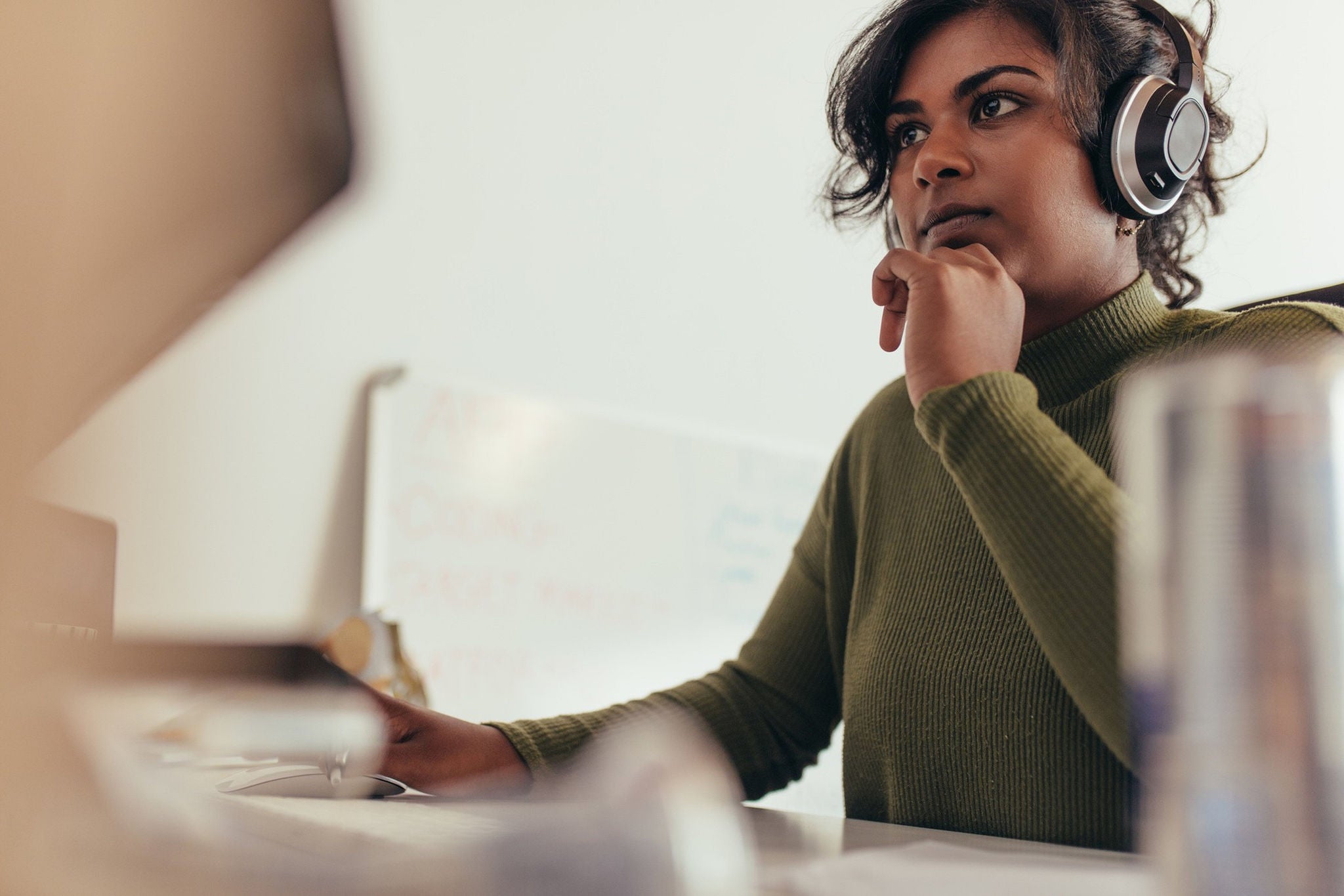  A lady working in the monitor by wearing headphones