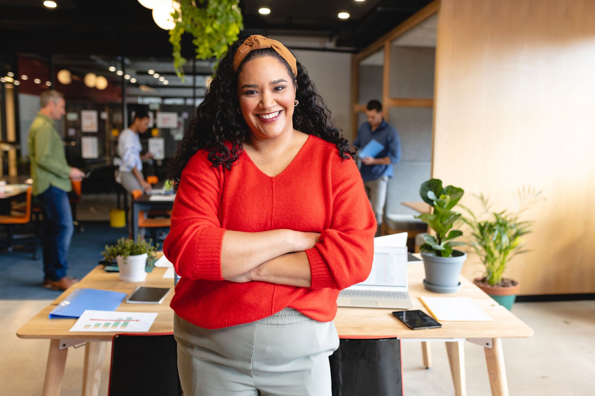 Portrait of confident mid adult biracial creative businesswoman in office