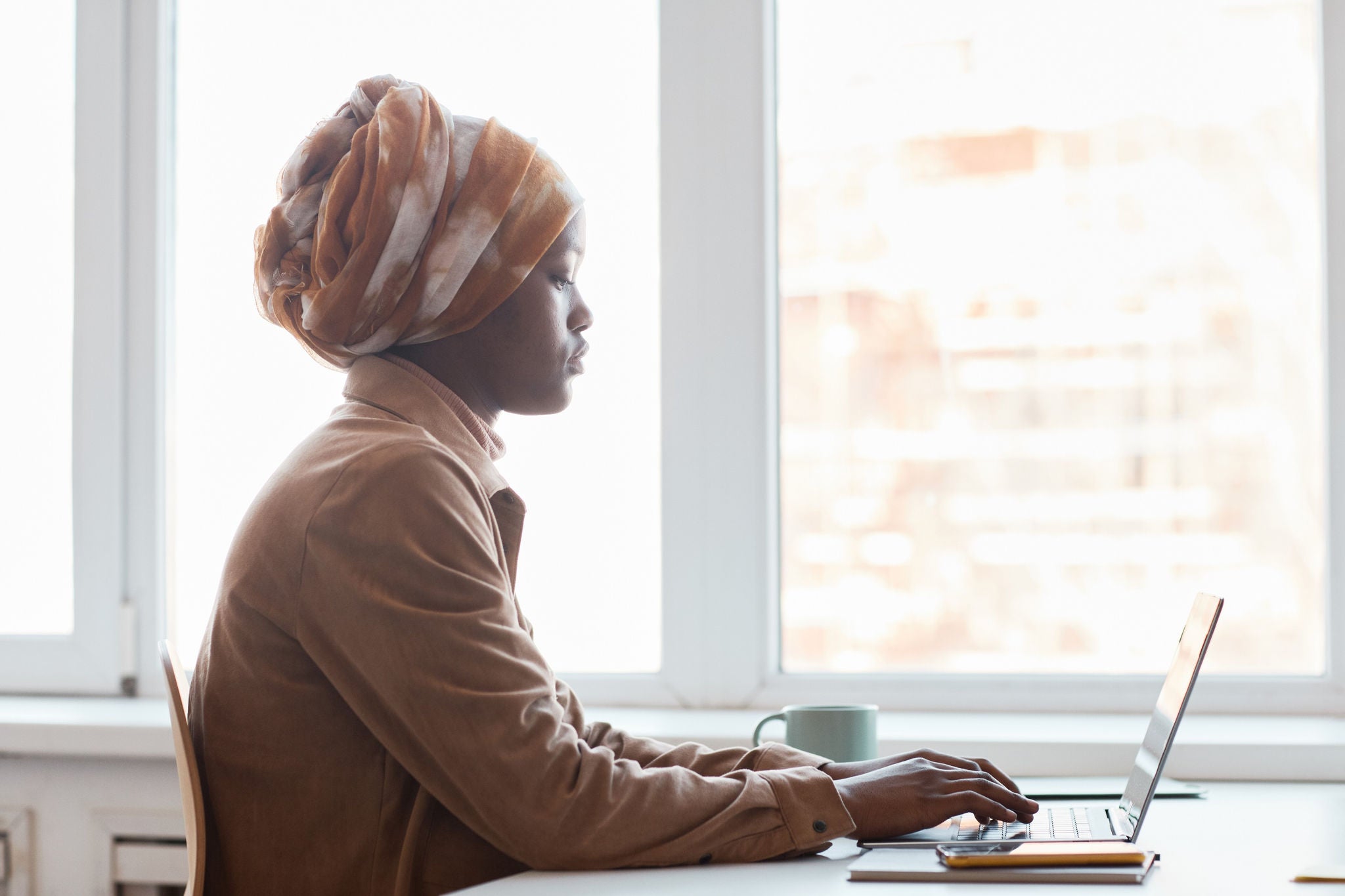 A woman is working in the laptop