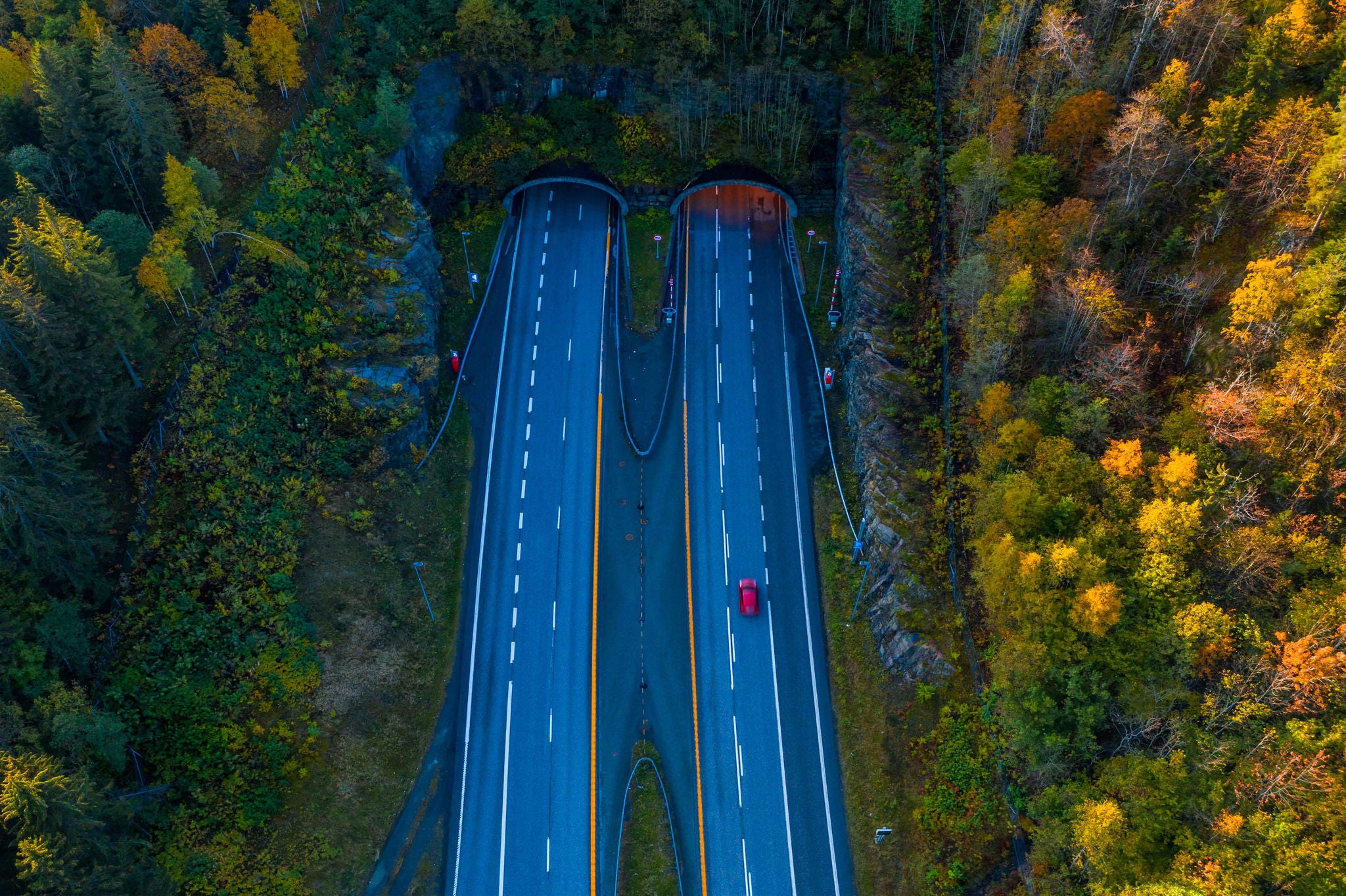 Areial view of a red car running through road