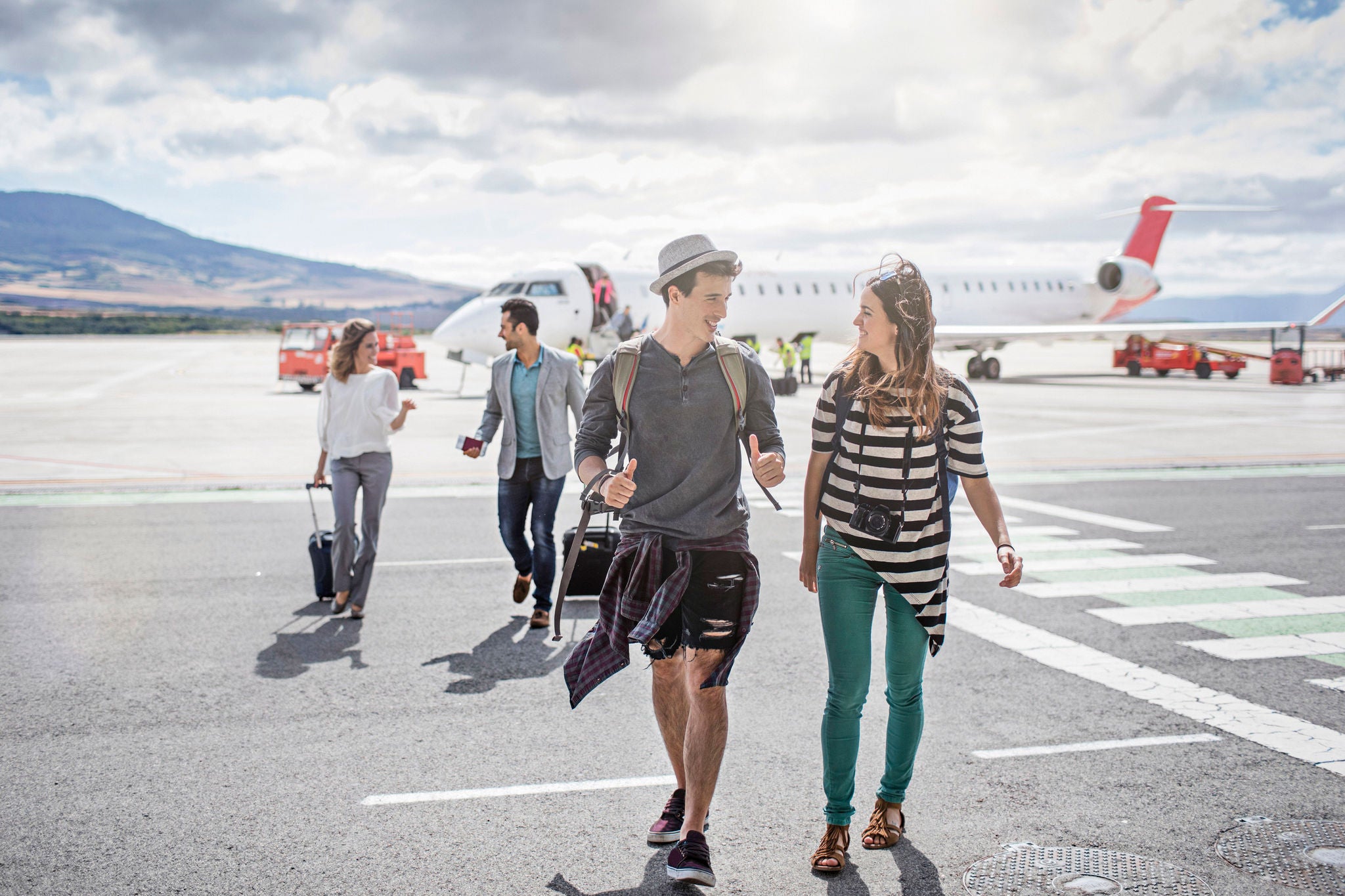 Passengers getting out of the airplane on a sunny day