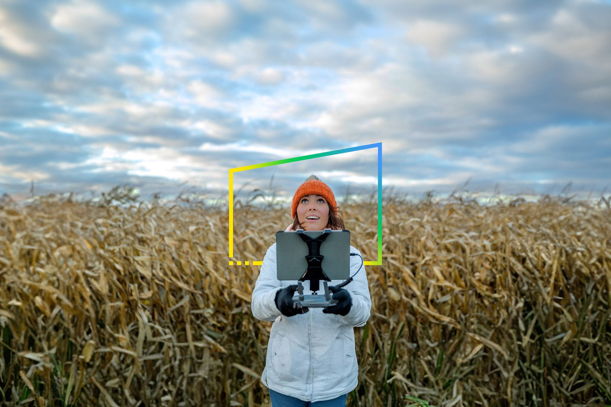 Woman Pilot Using Drone Remote Controller in corn field