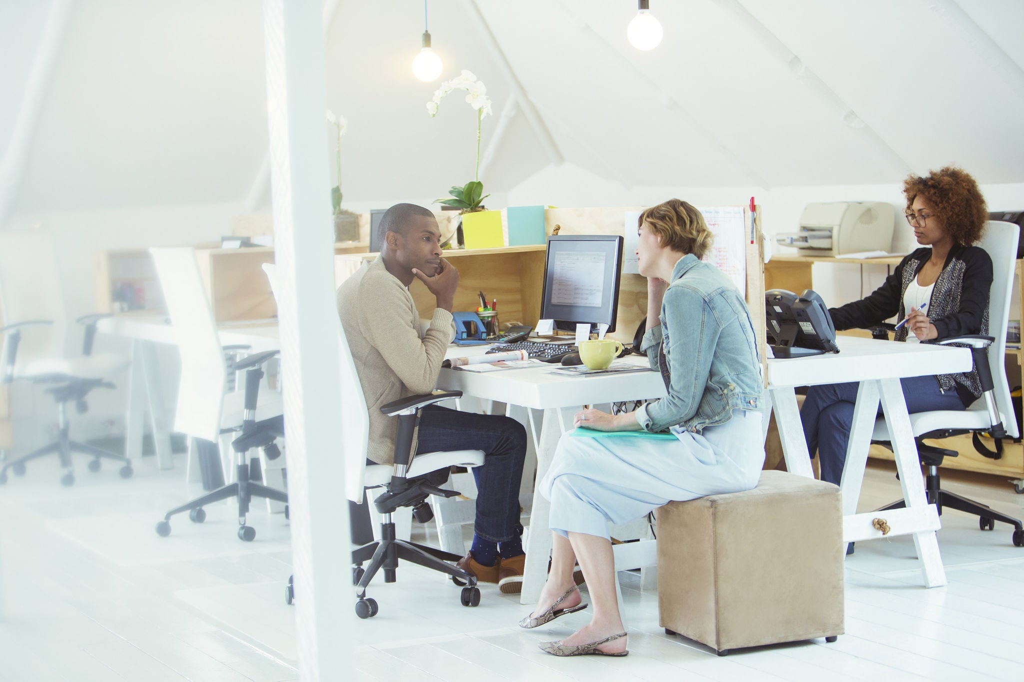 Two employees having a conversation in an office