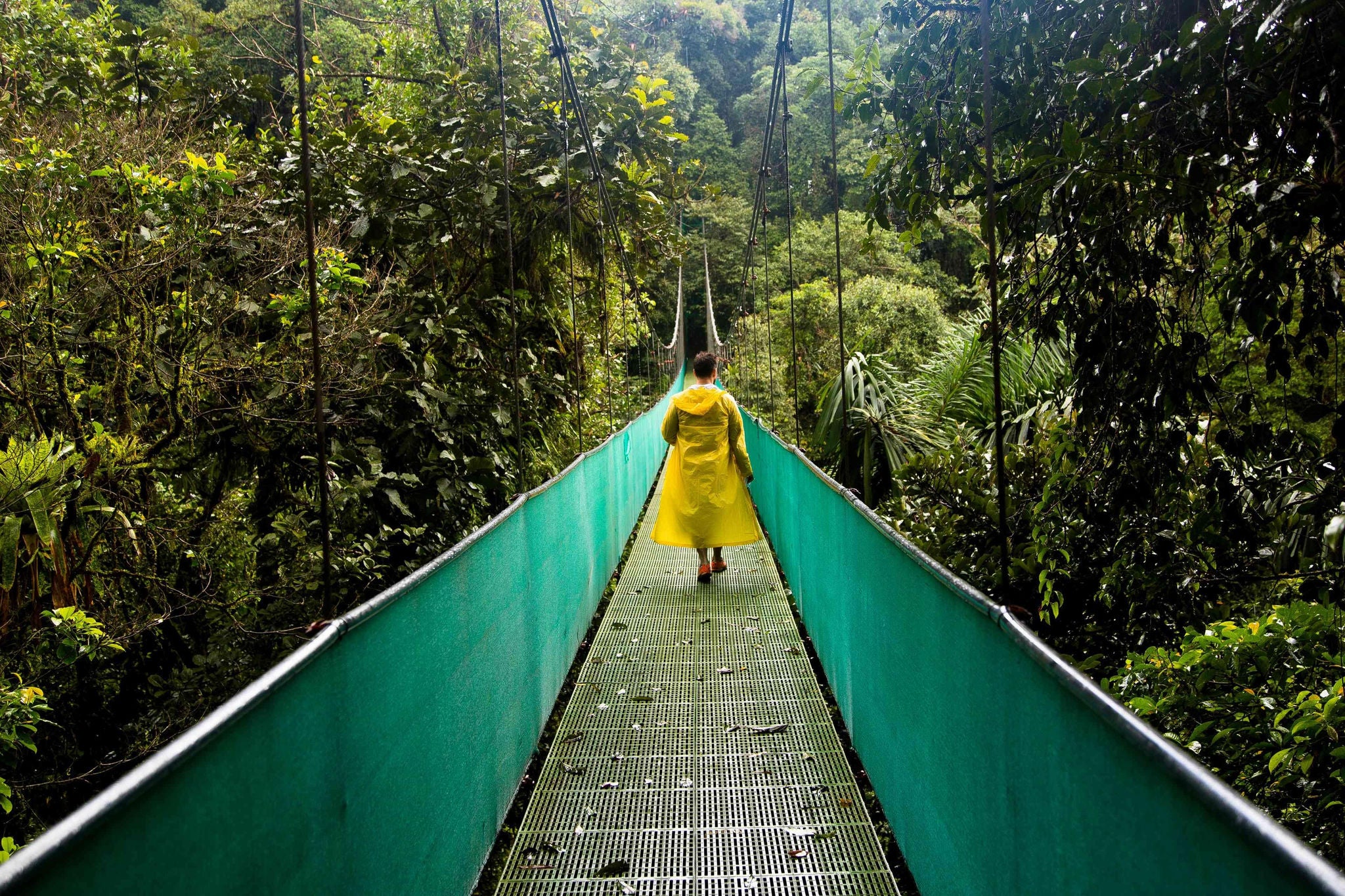 man-walking-across-a-bridge