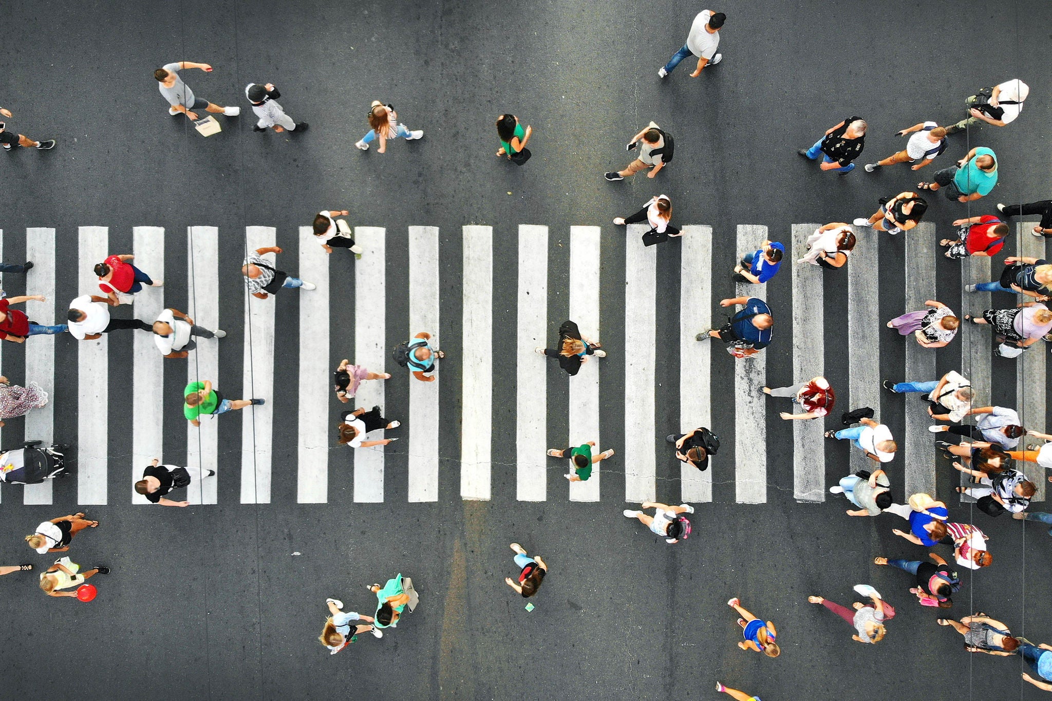 Top view of people walking on road from drone