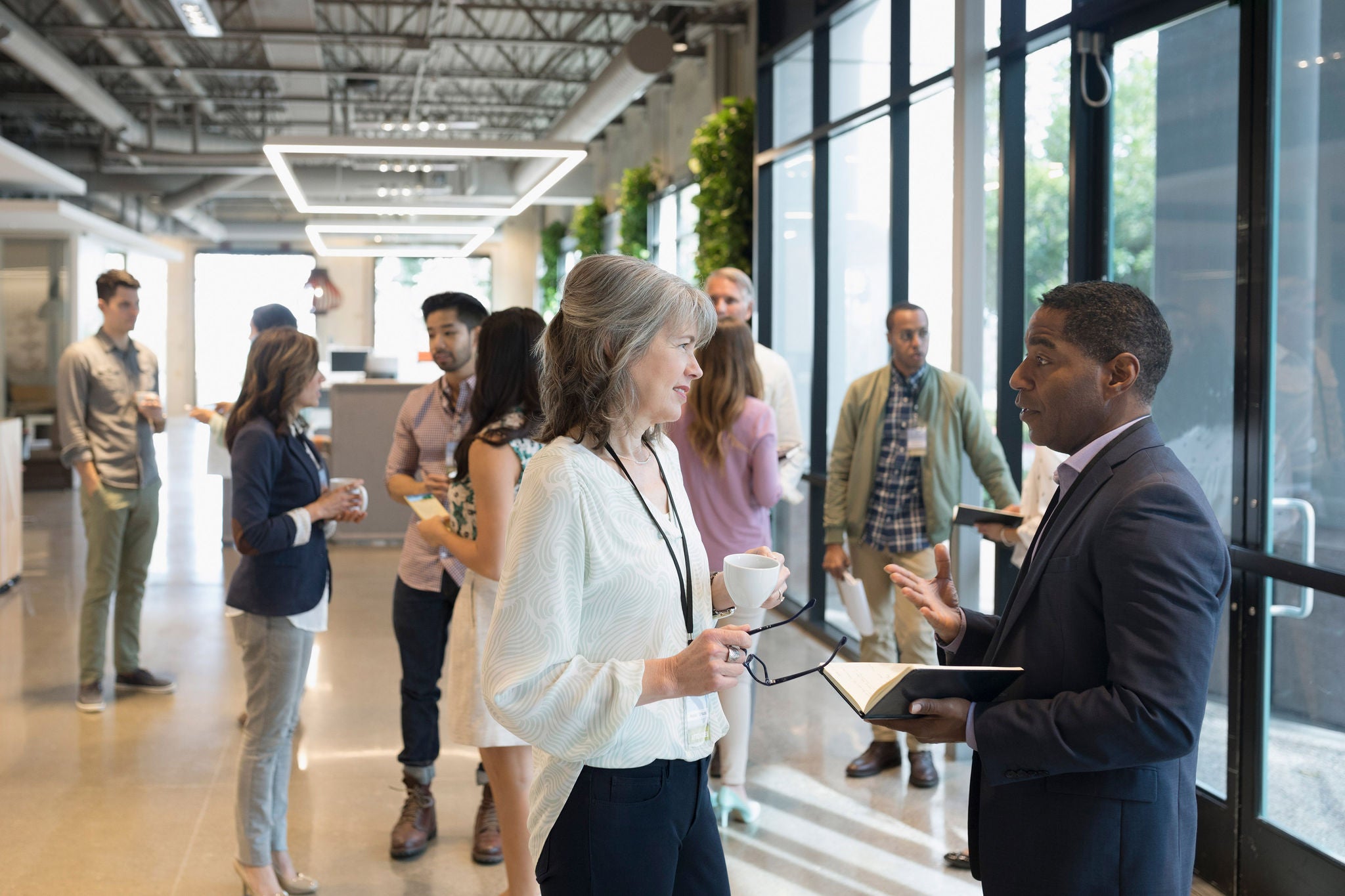 Business people networking in office lobby