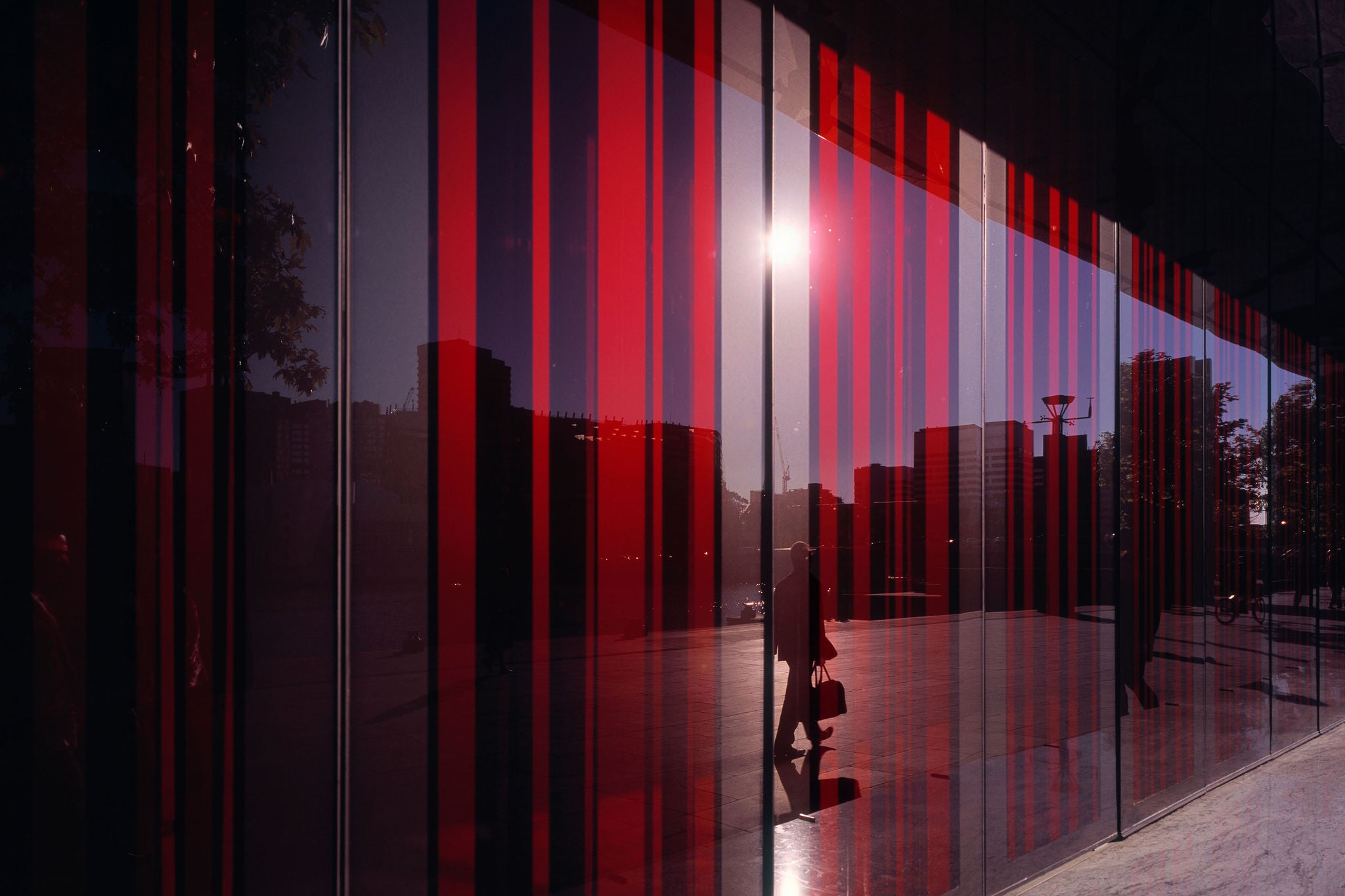 Colorful glass facade of building reflecting city life, Melbourne, Australia.