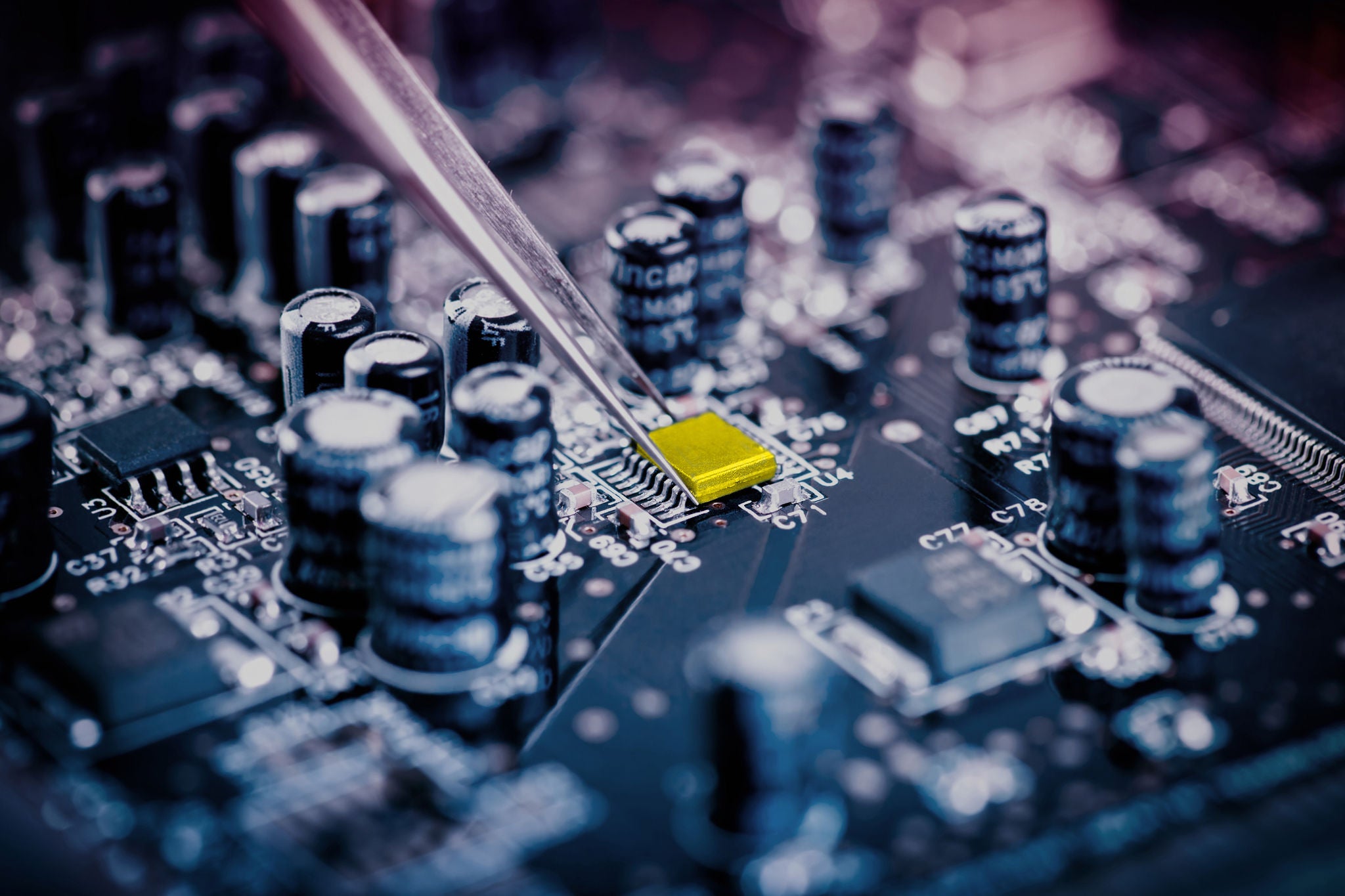 Circuit board being assembled with tweezers