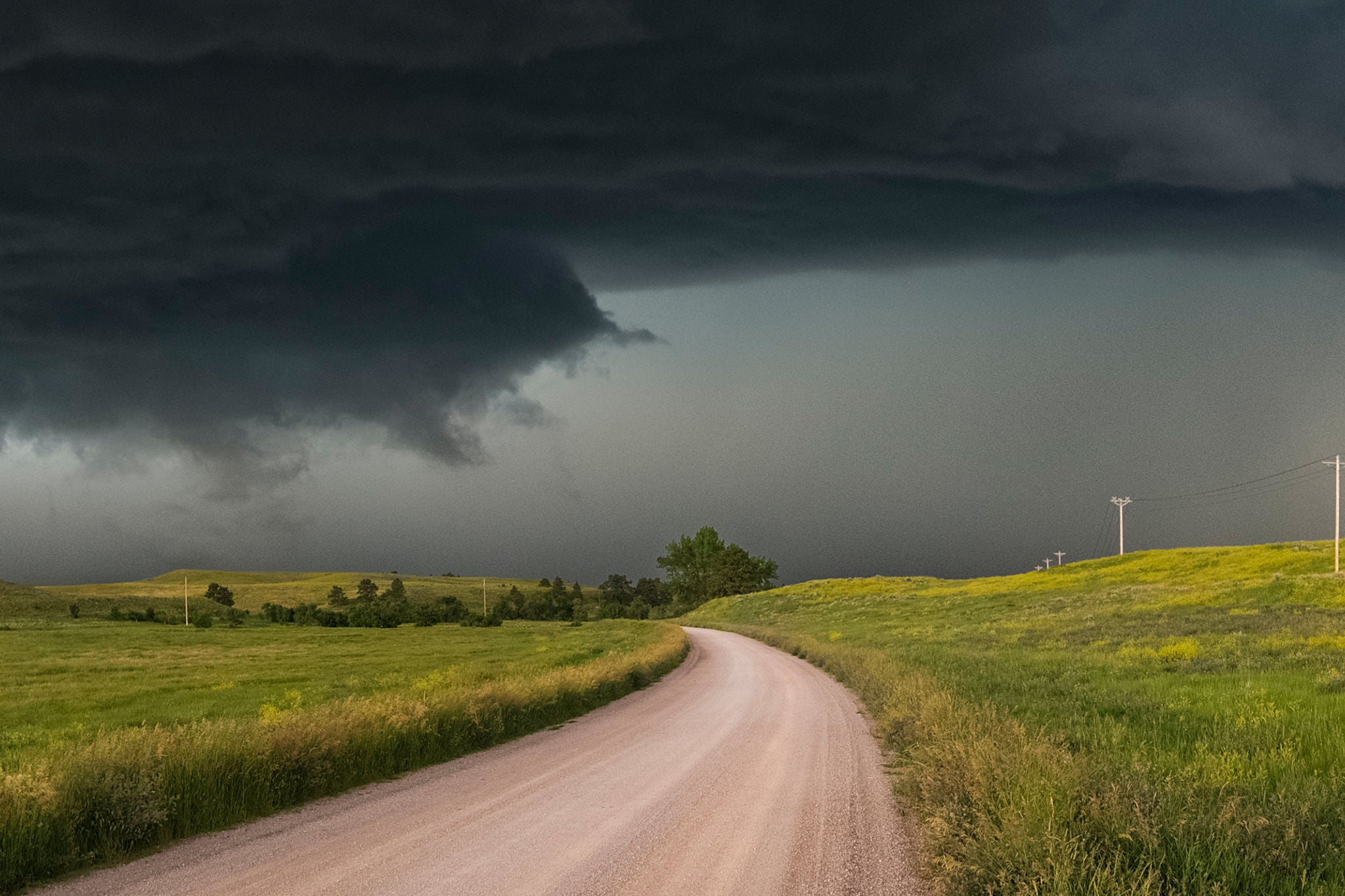 Dark thick clouds above country road static