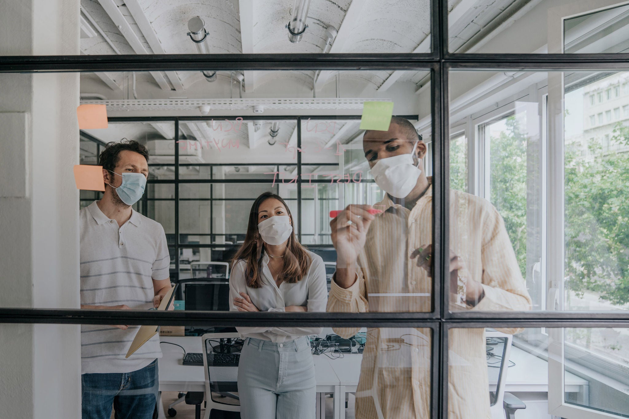 Businesspeople brainstorming work during the Covid-19 pandemic