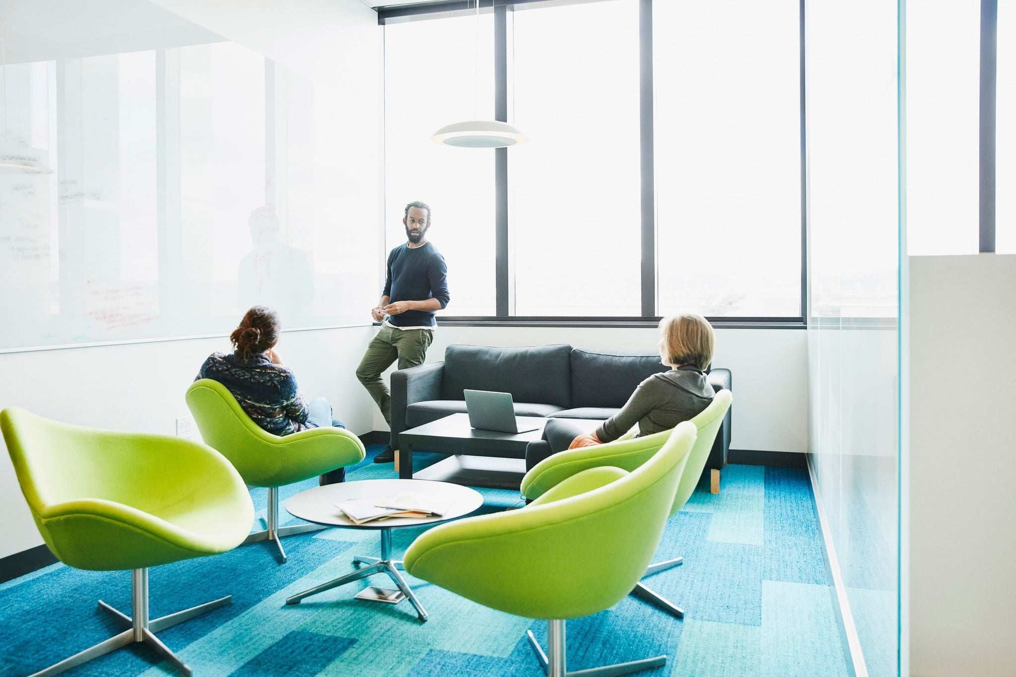 Colleagues working on project on whiteboard in conference room