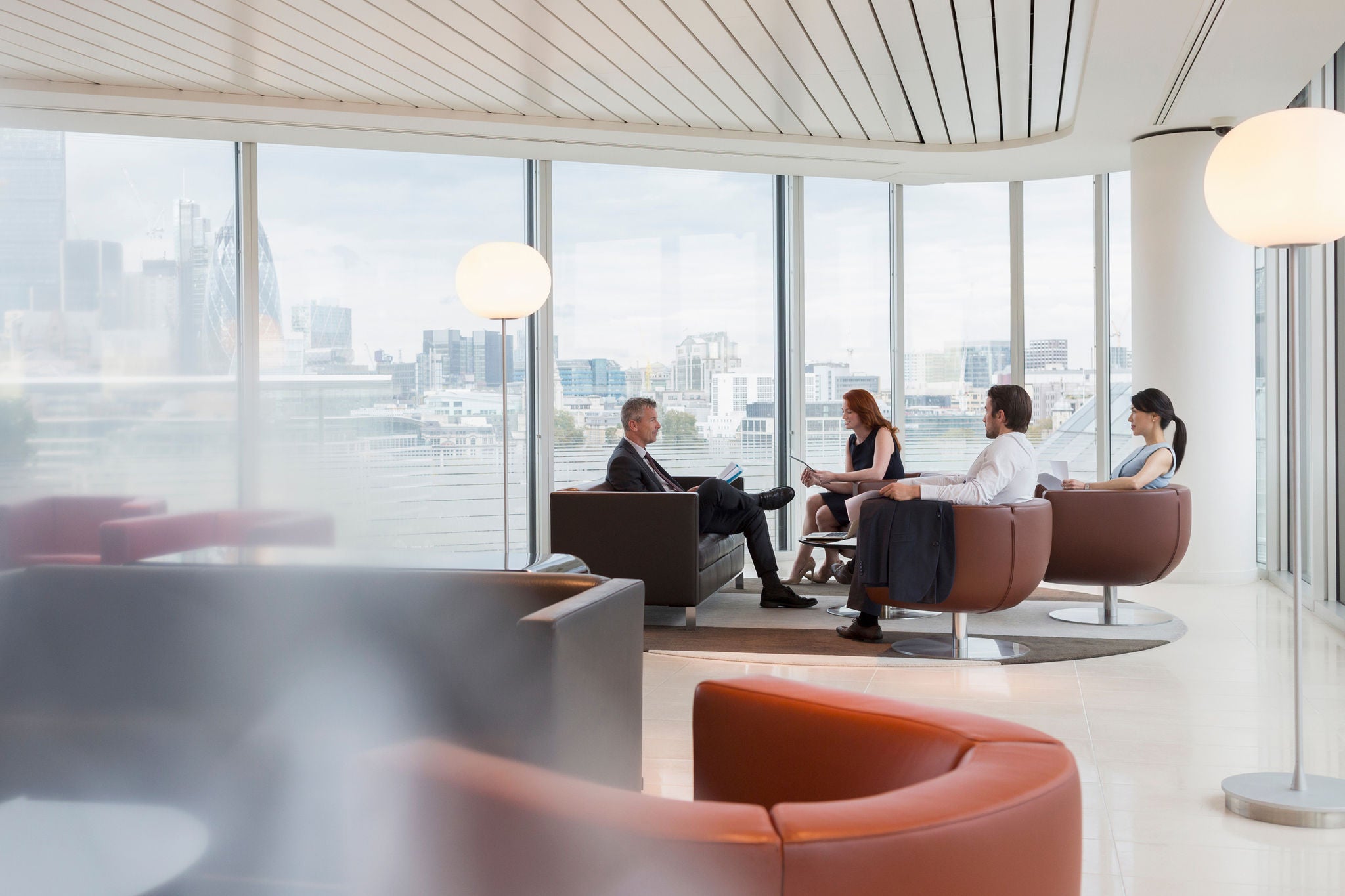 Business people meeting in urban highrise office lounge