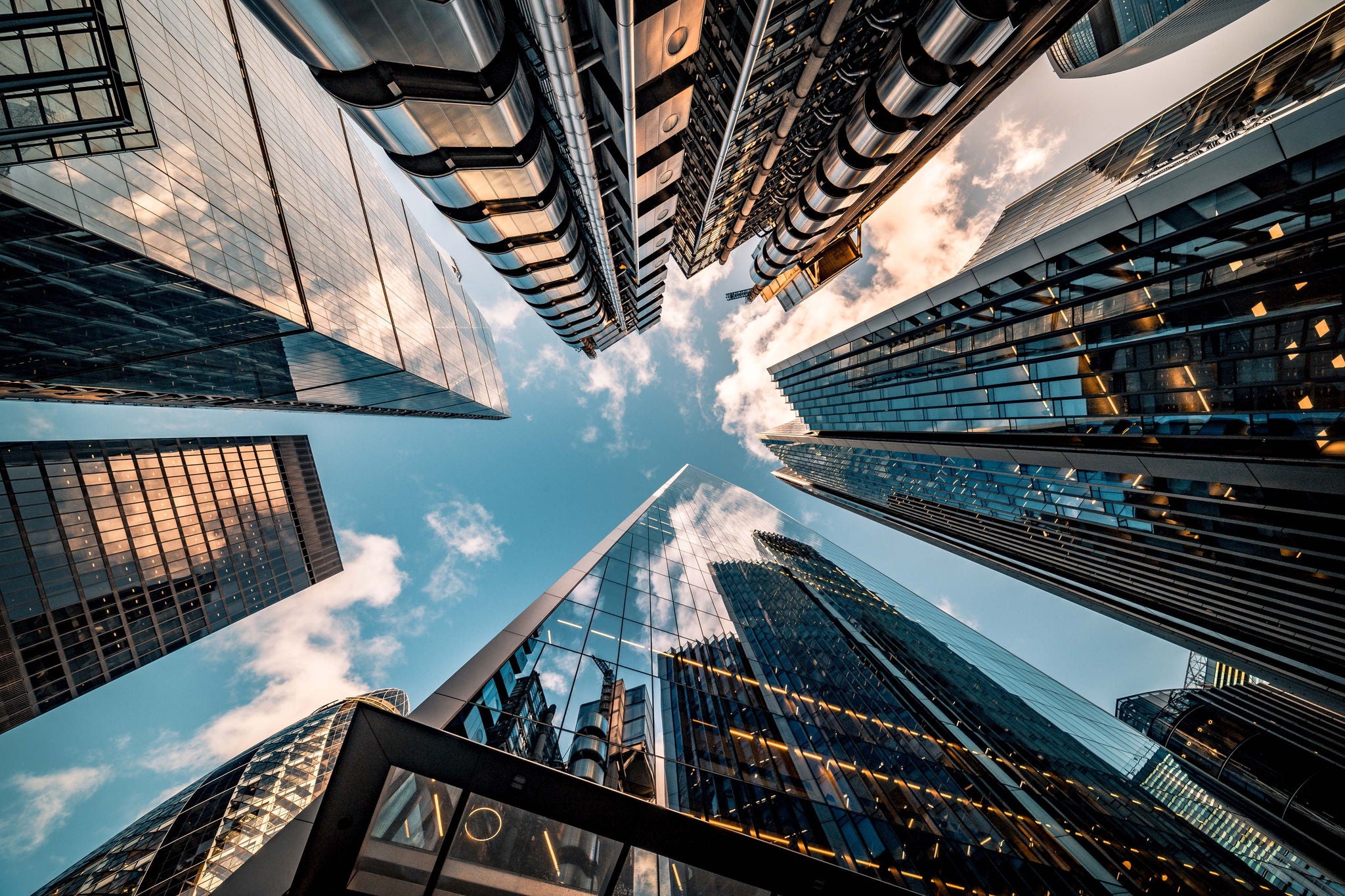 Highly detailed abstract wide angle view up towards the sky in the financial district of London City and its ultra modern contemporary buildings with unique architecture. Shot on Canon EOS R full frame with 10mm wide angle lens. Image is ideal for background.