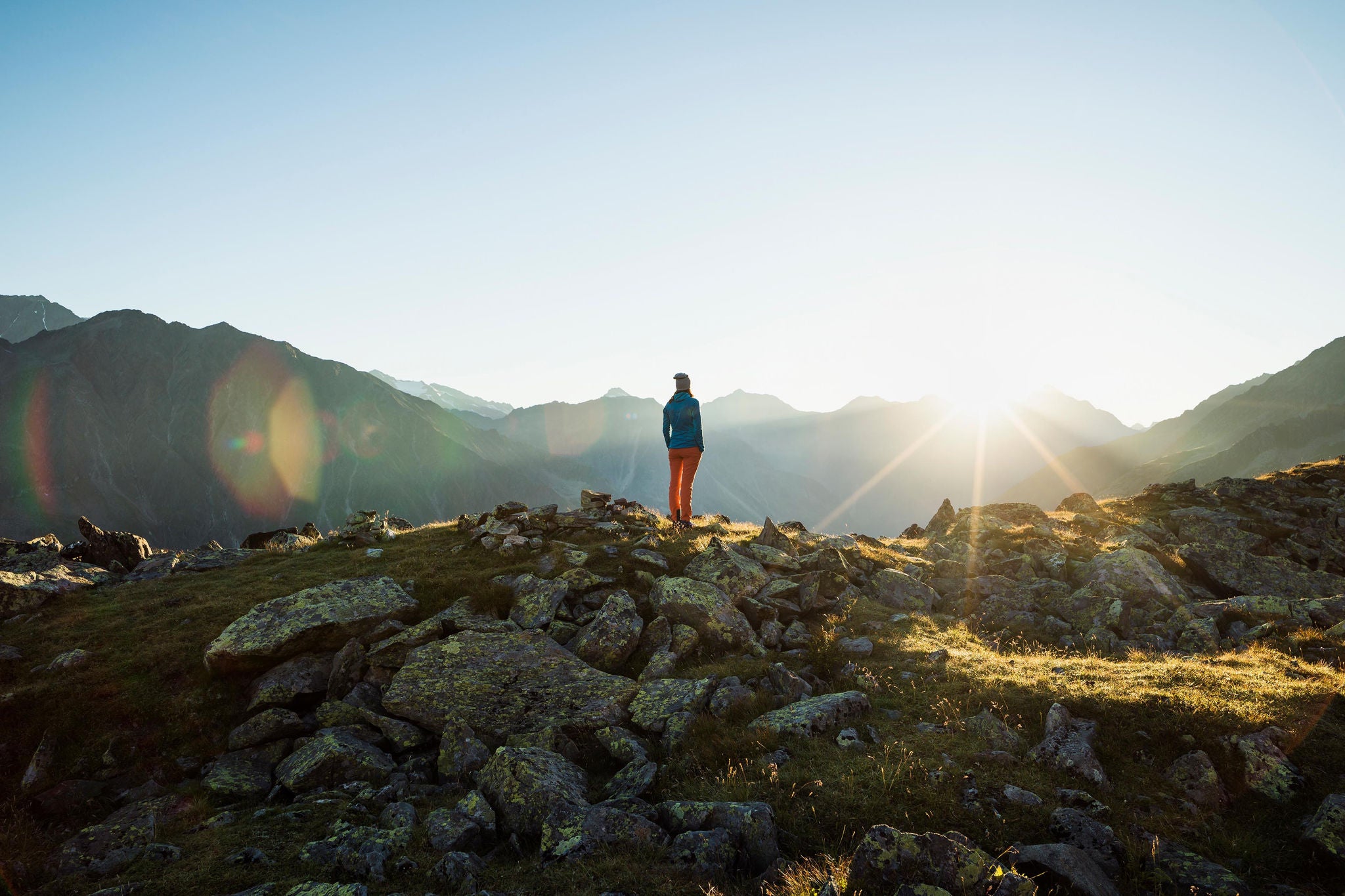 Woman enjoying sunrise in the mountains