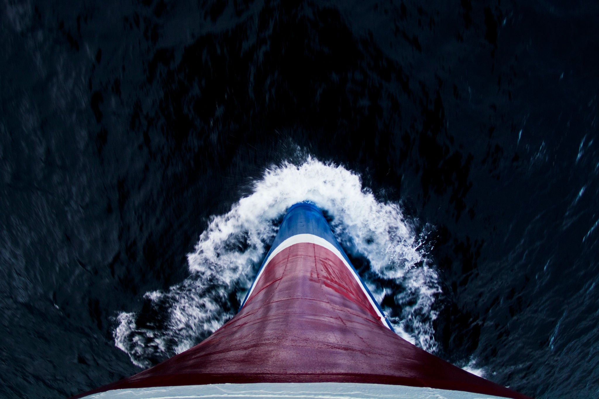 The steel bow of an ice strengthened ecotourism ship ploughs the sea.