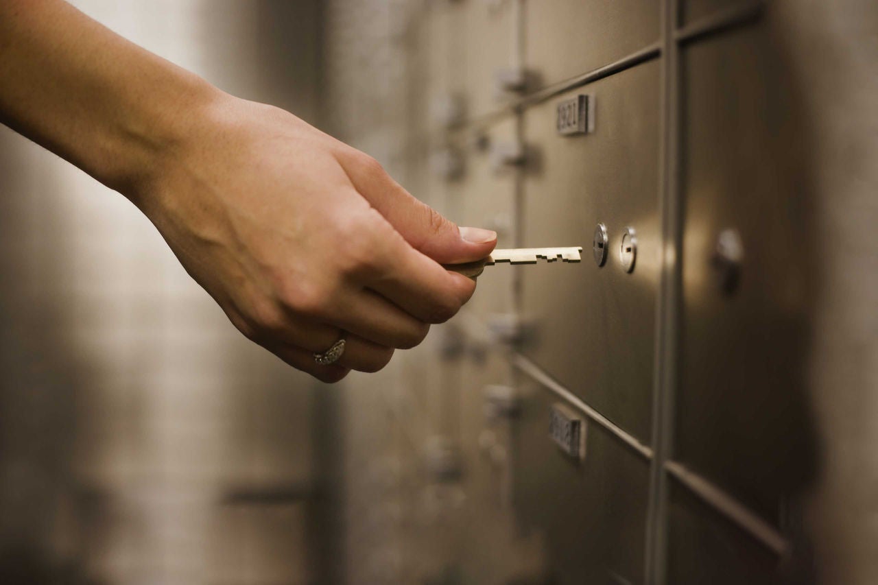 Women holding key to safety deposit box