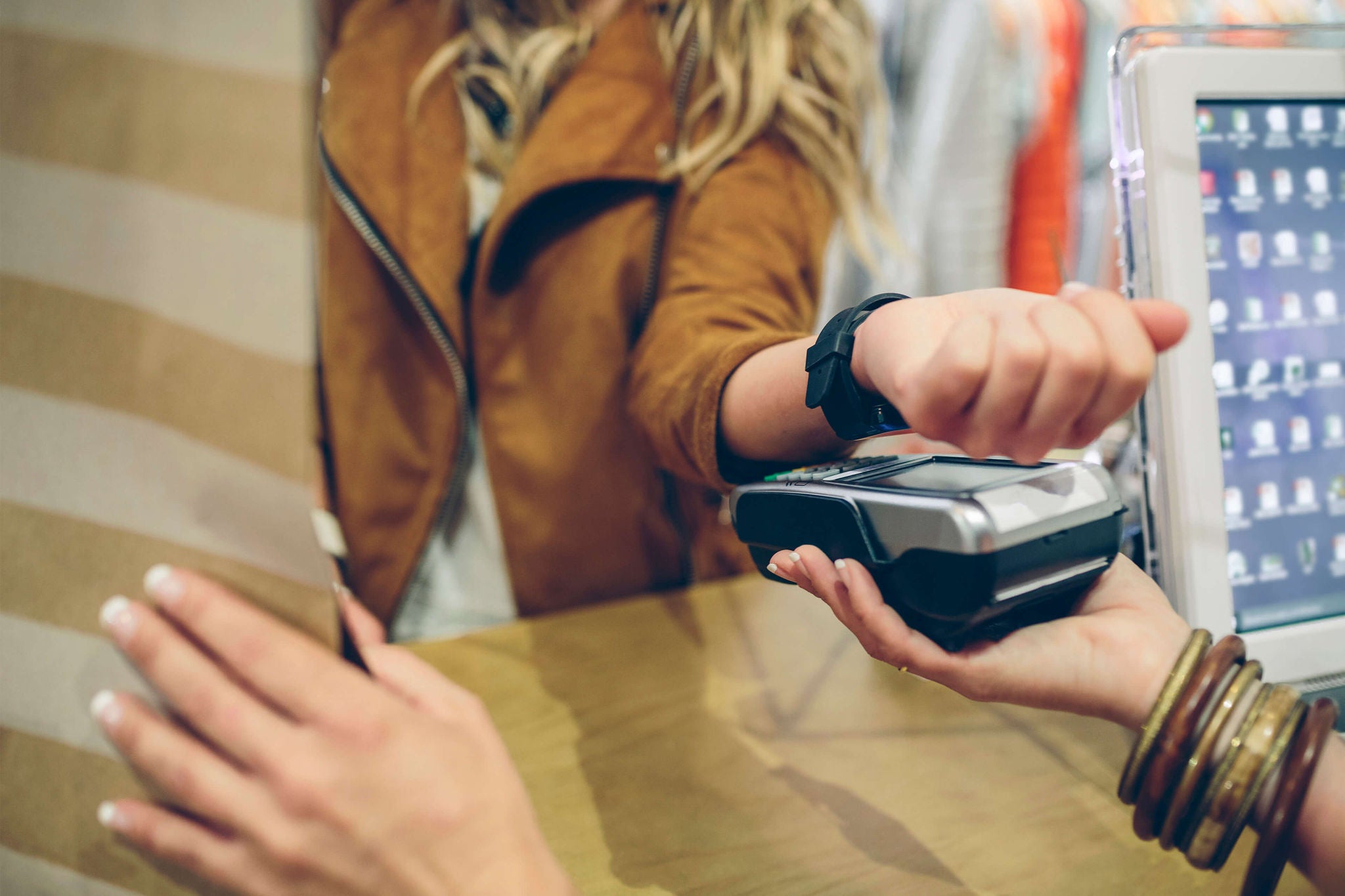 Women making contactless transaction through her watch