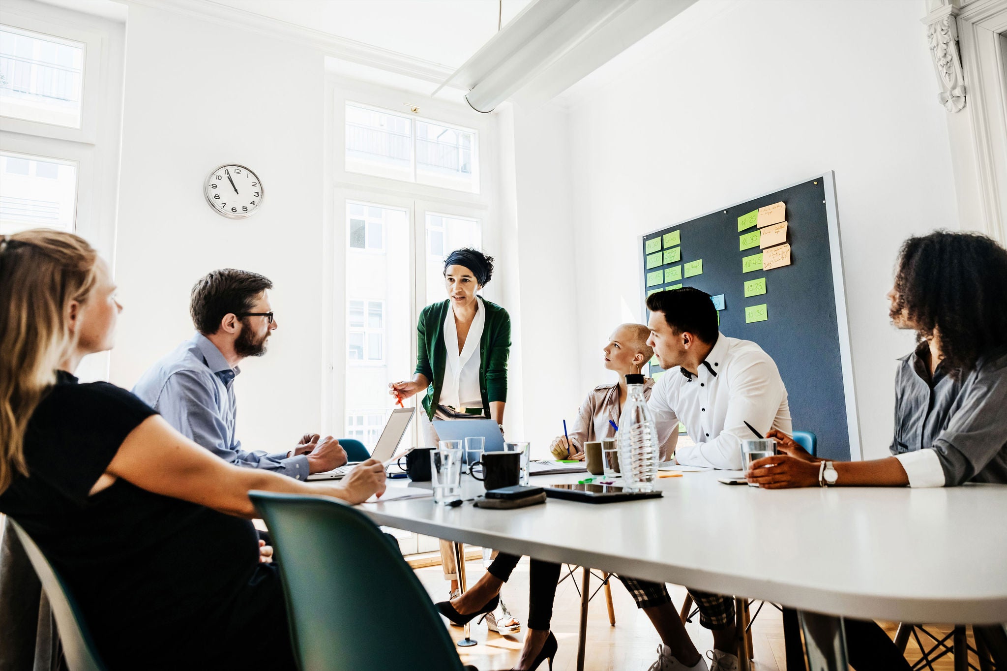 Businesswoman leading group during brainstorming meeting