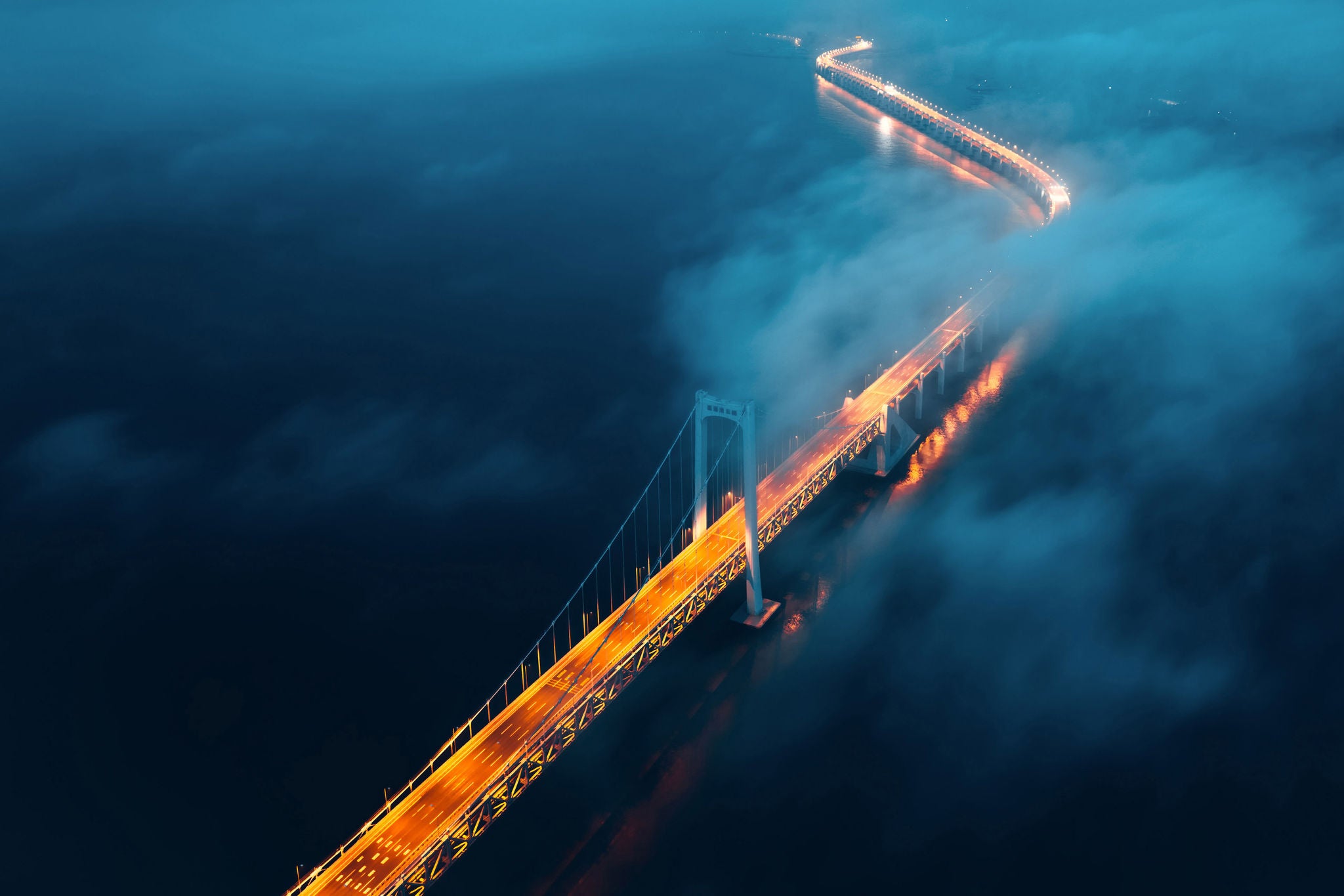 A cross-sea bridge in the fog at night