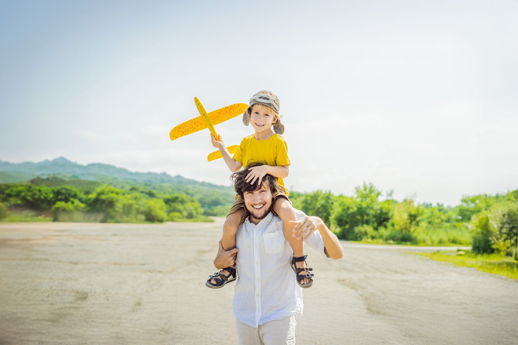 EY - Happy father and son playing with toy airplane